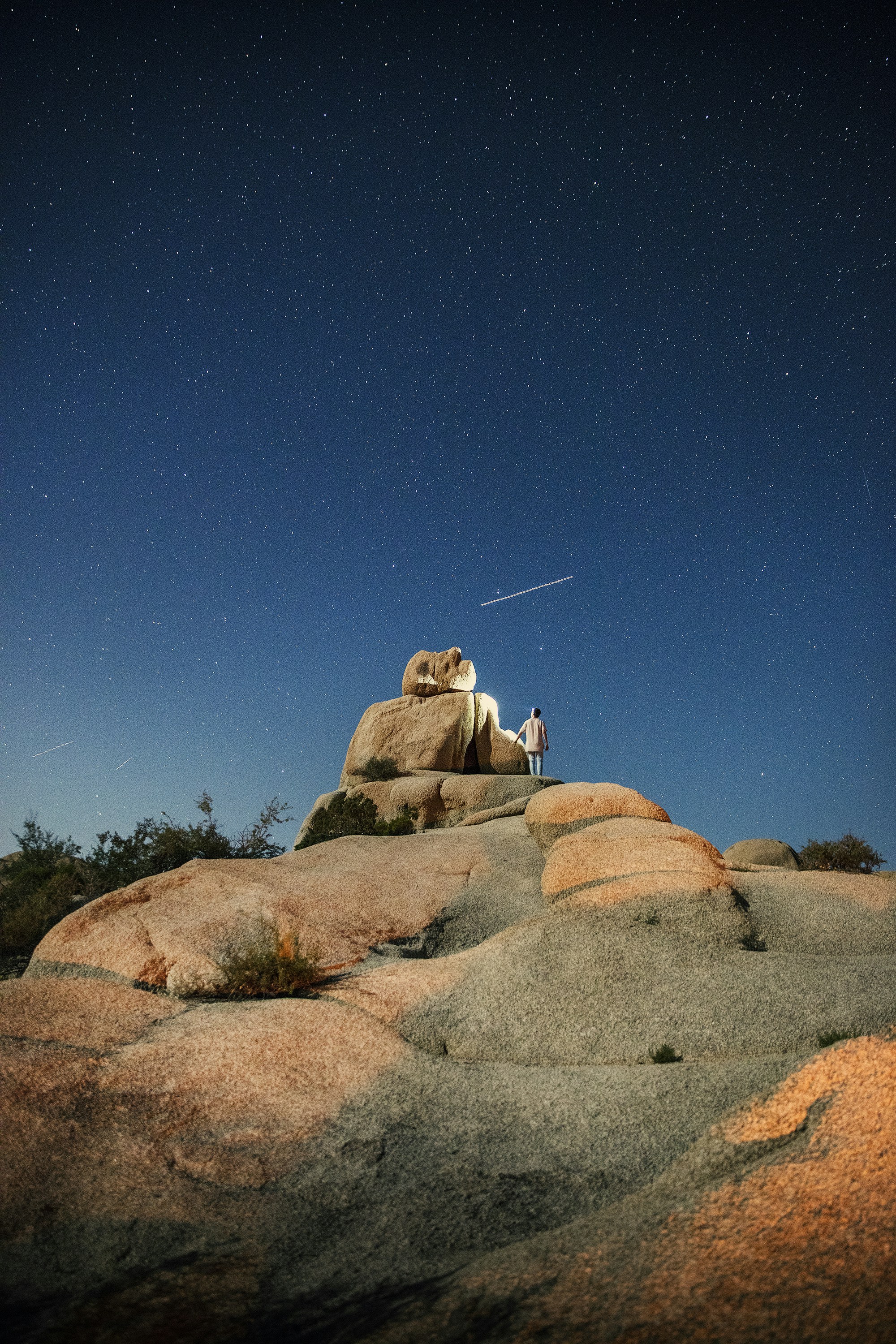 Stargazer on Rock Under Starry Night