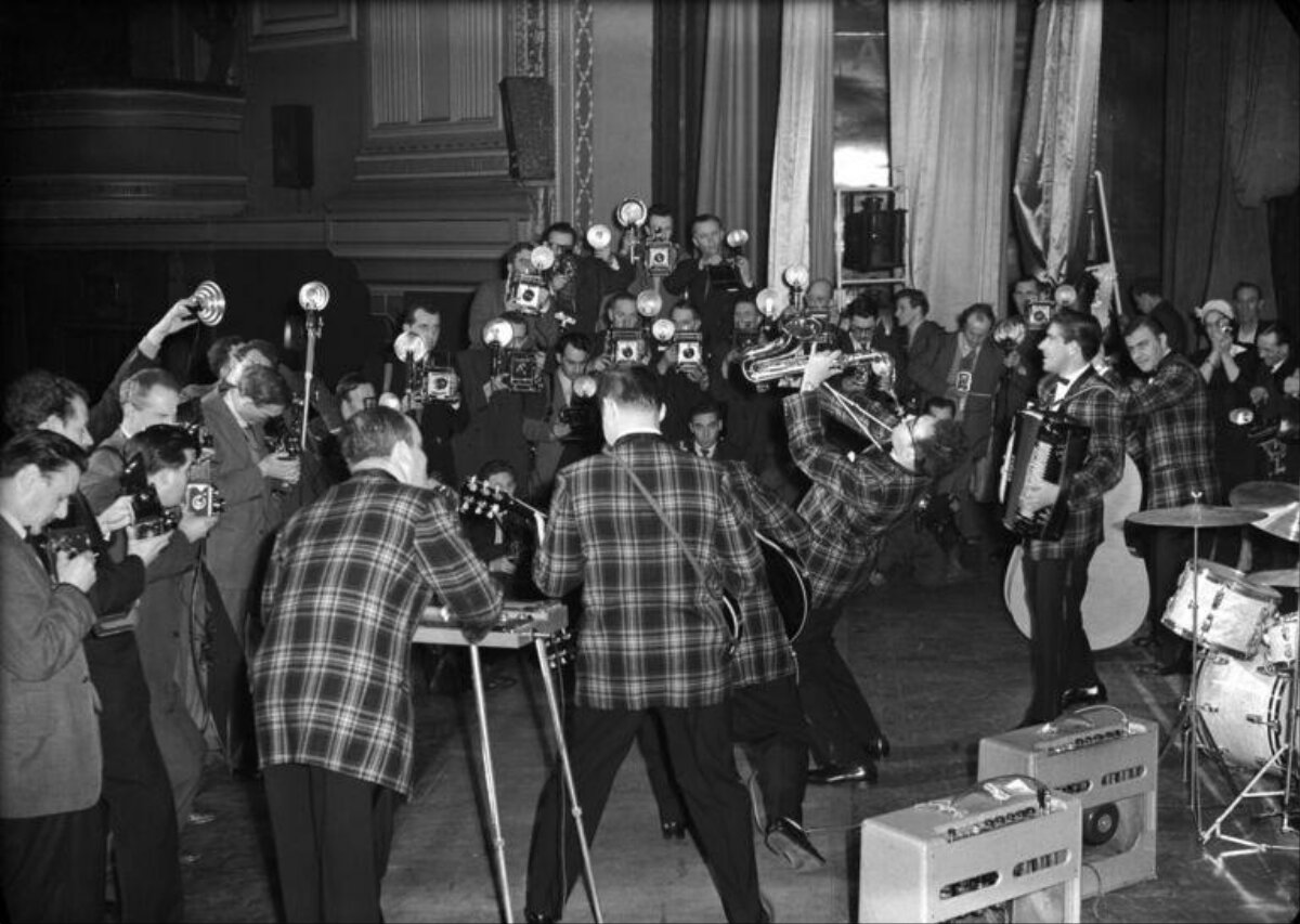Band Performance Surrounded by Photographers