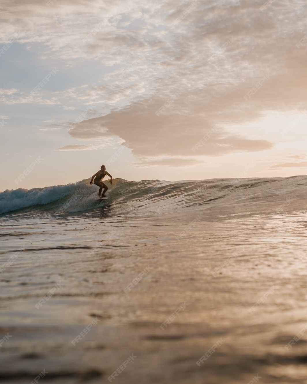 Surfer Riding Wave at Sunset