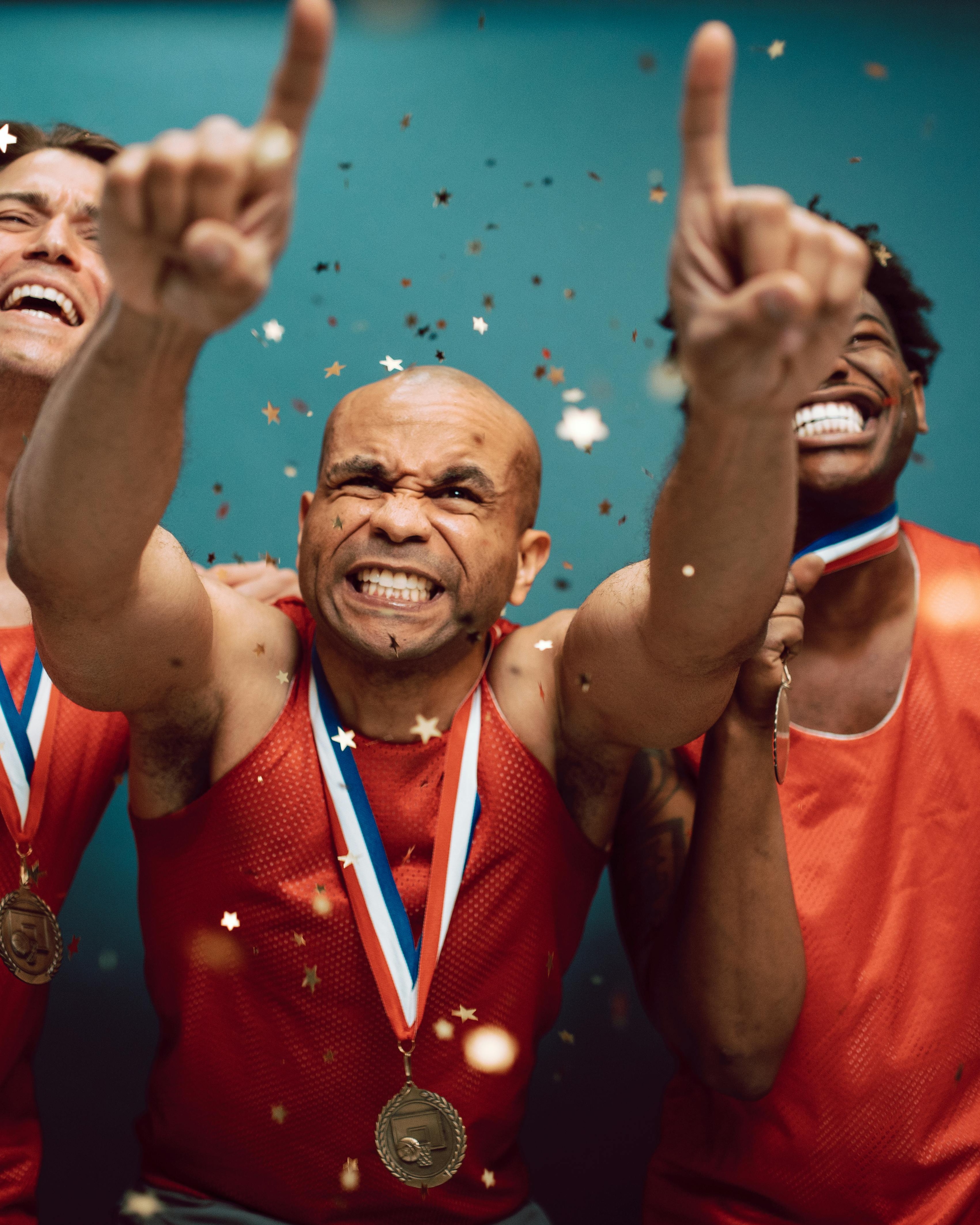 Three Athletes Celebrate Medal Victory