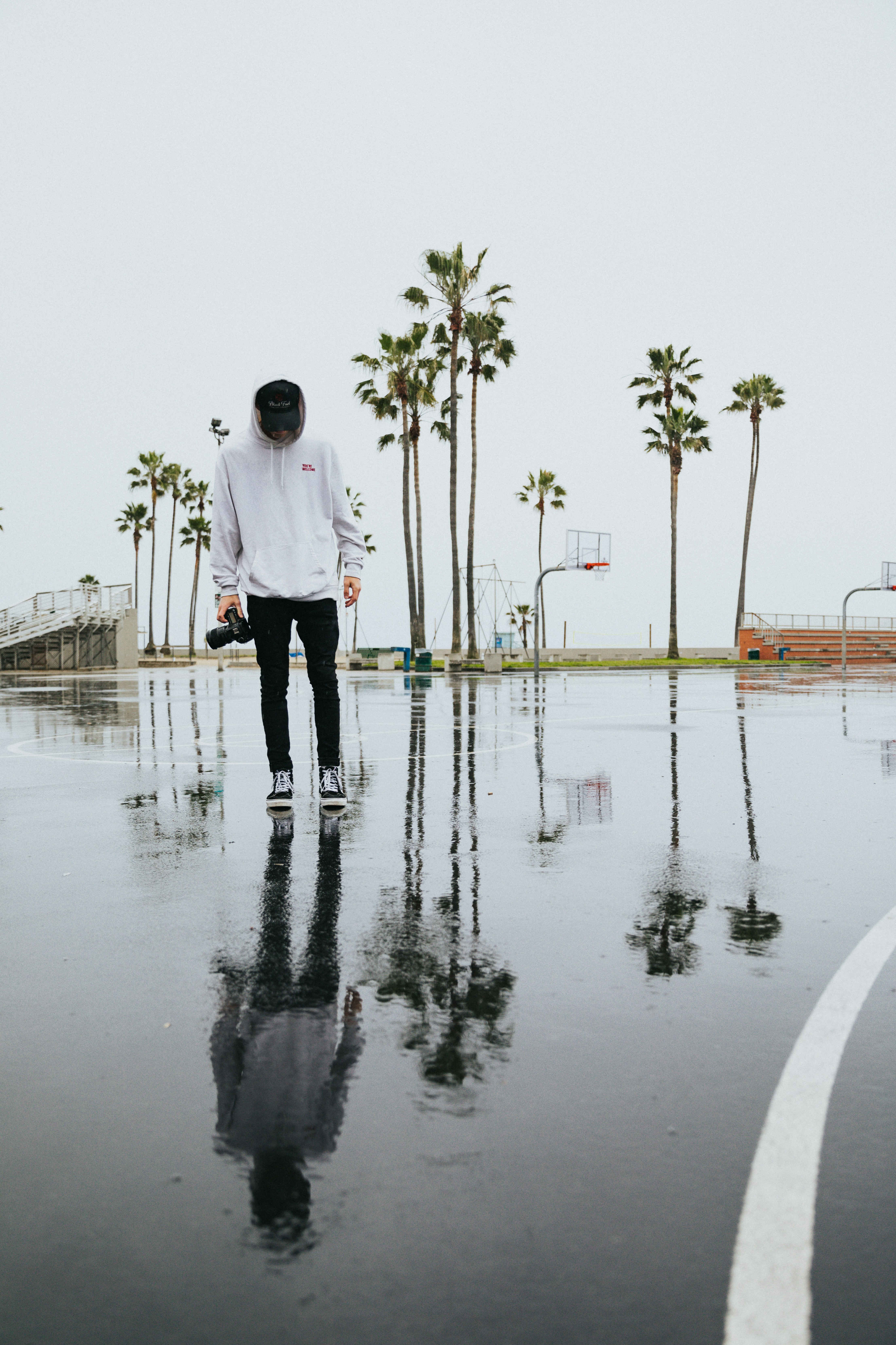 Photographer on Wet Basketball Court