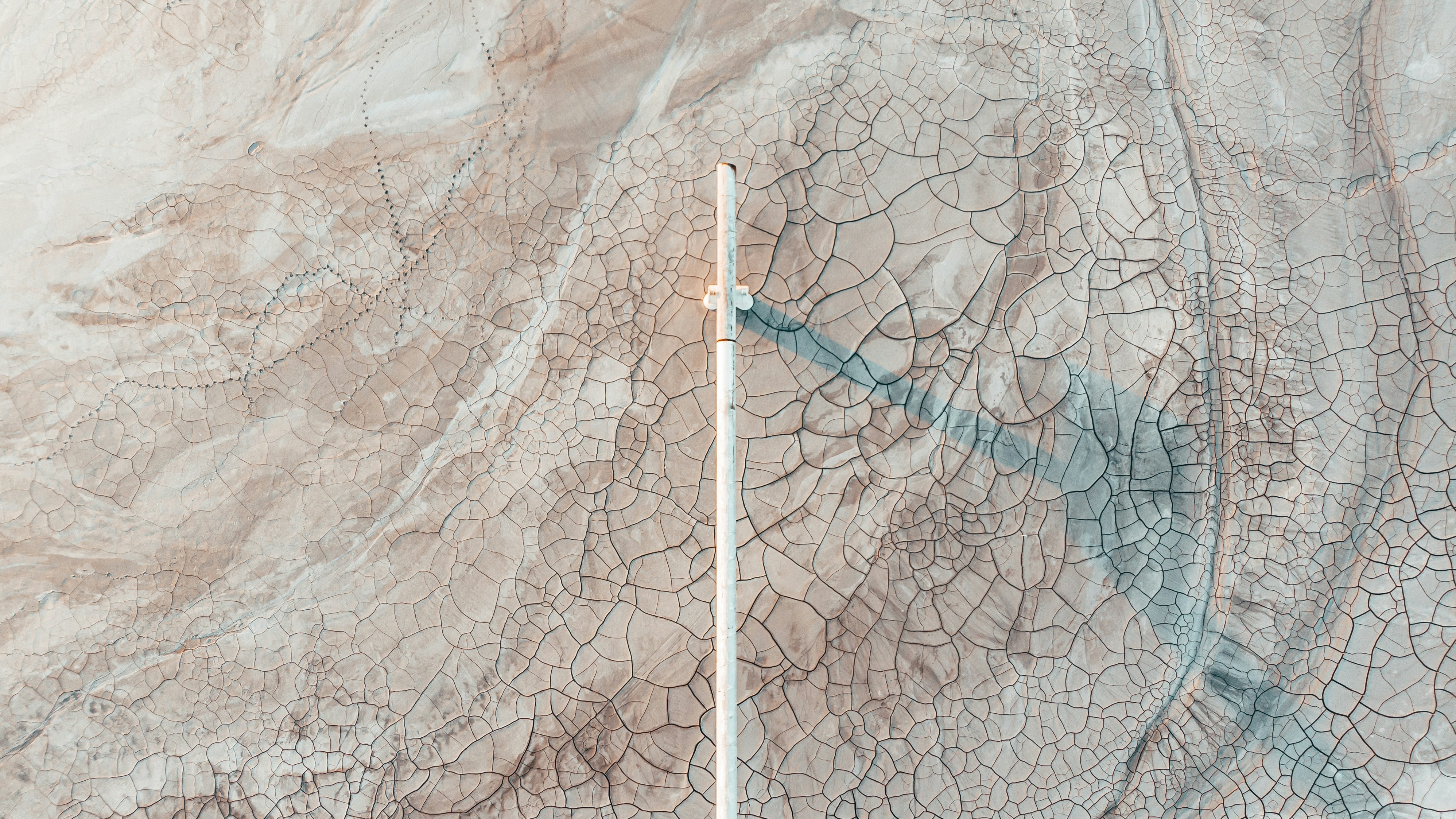 Cracked Dry Land with Vertical Pole