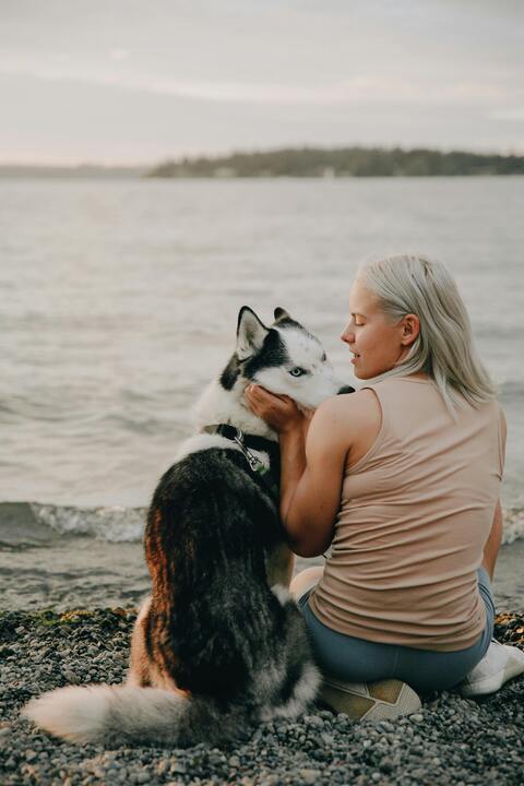 Woman with Husky at Pebbled Beach