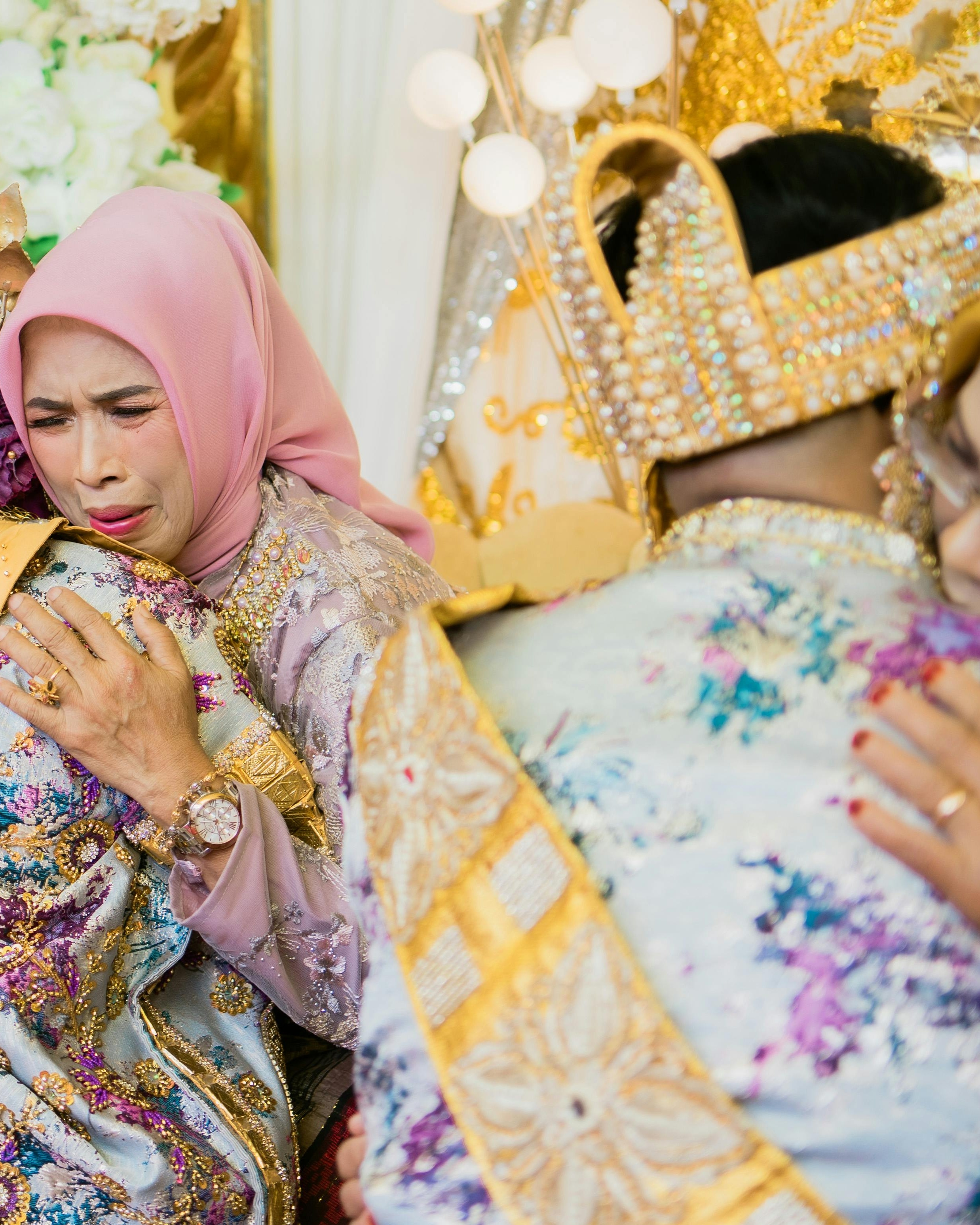 Emotional Mother Hugging Groom at Wedding