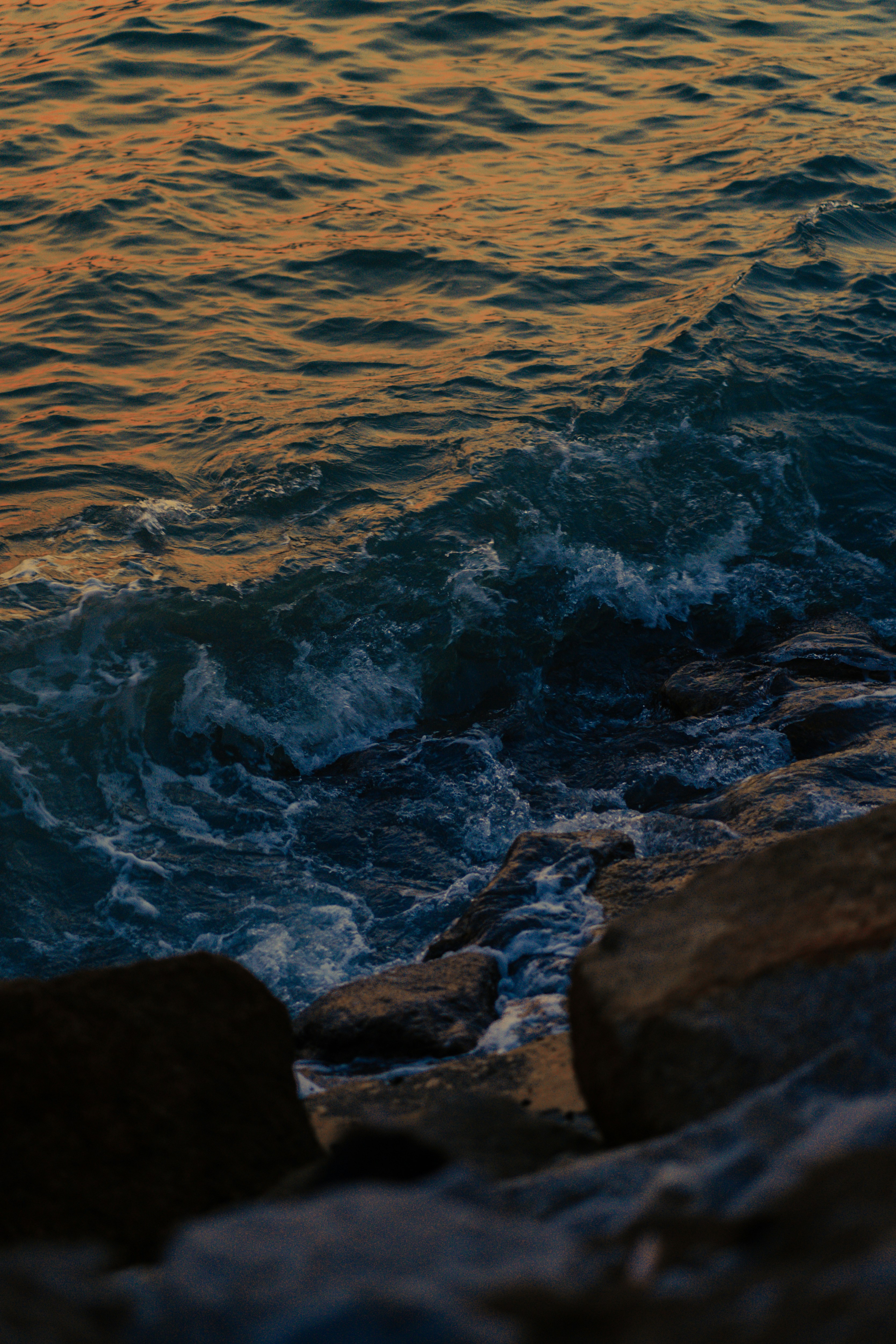 Sunset Waves Hitting Shore Rocks