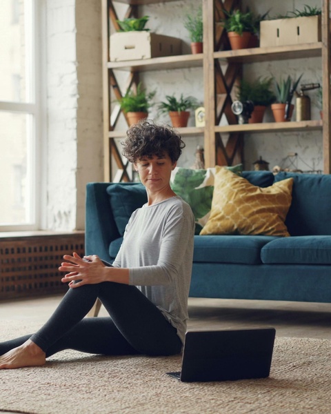Woman following online workout at home