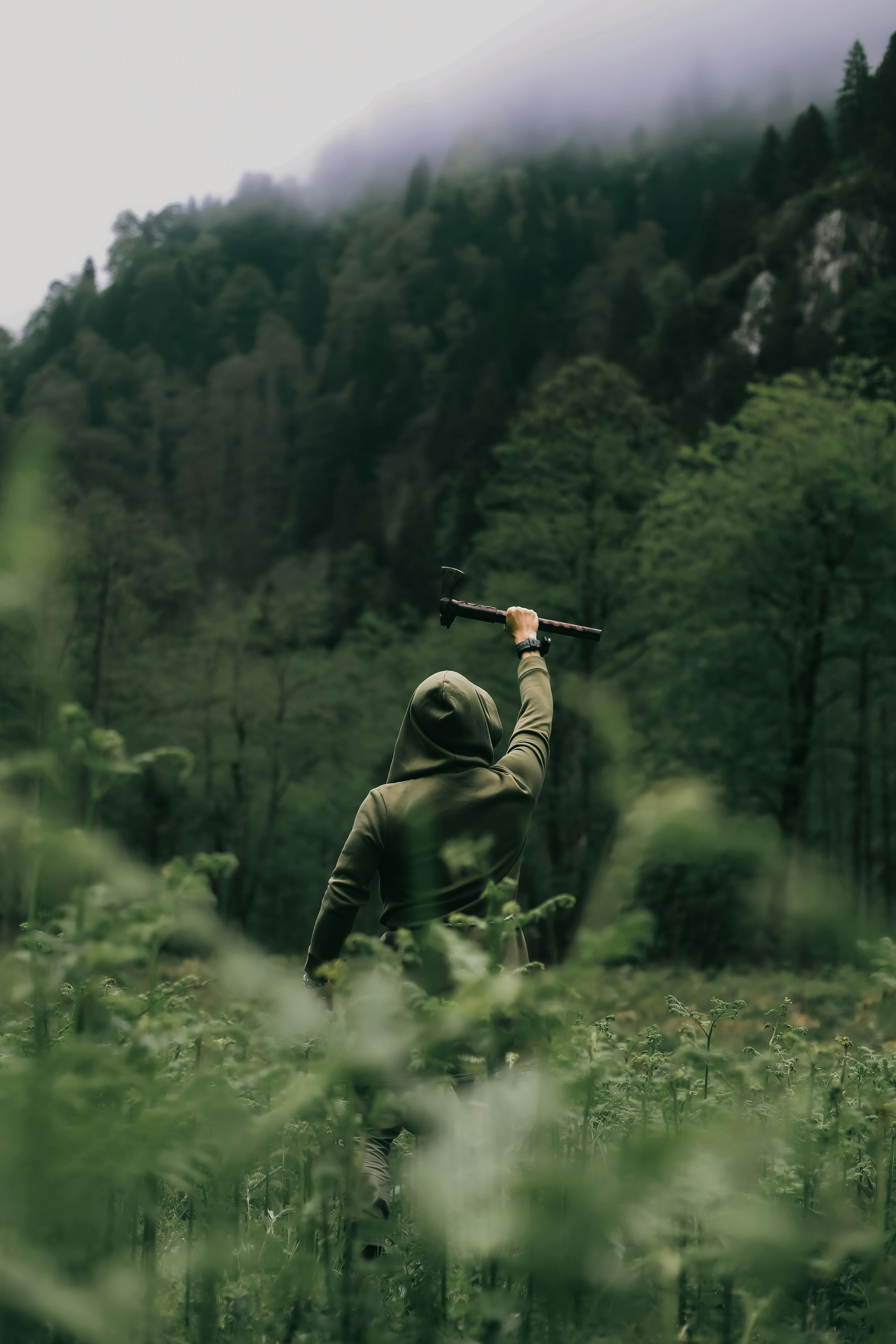 Hiker Raises Axe In Misty Forest
