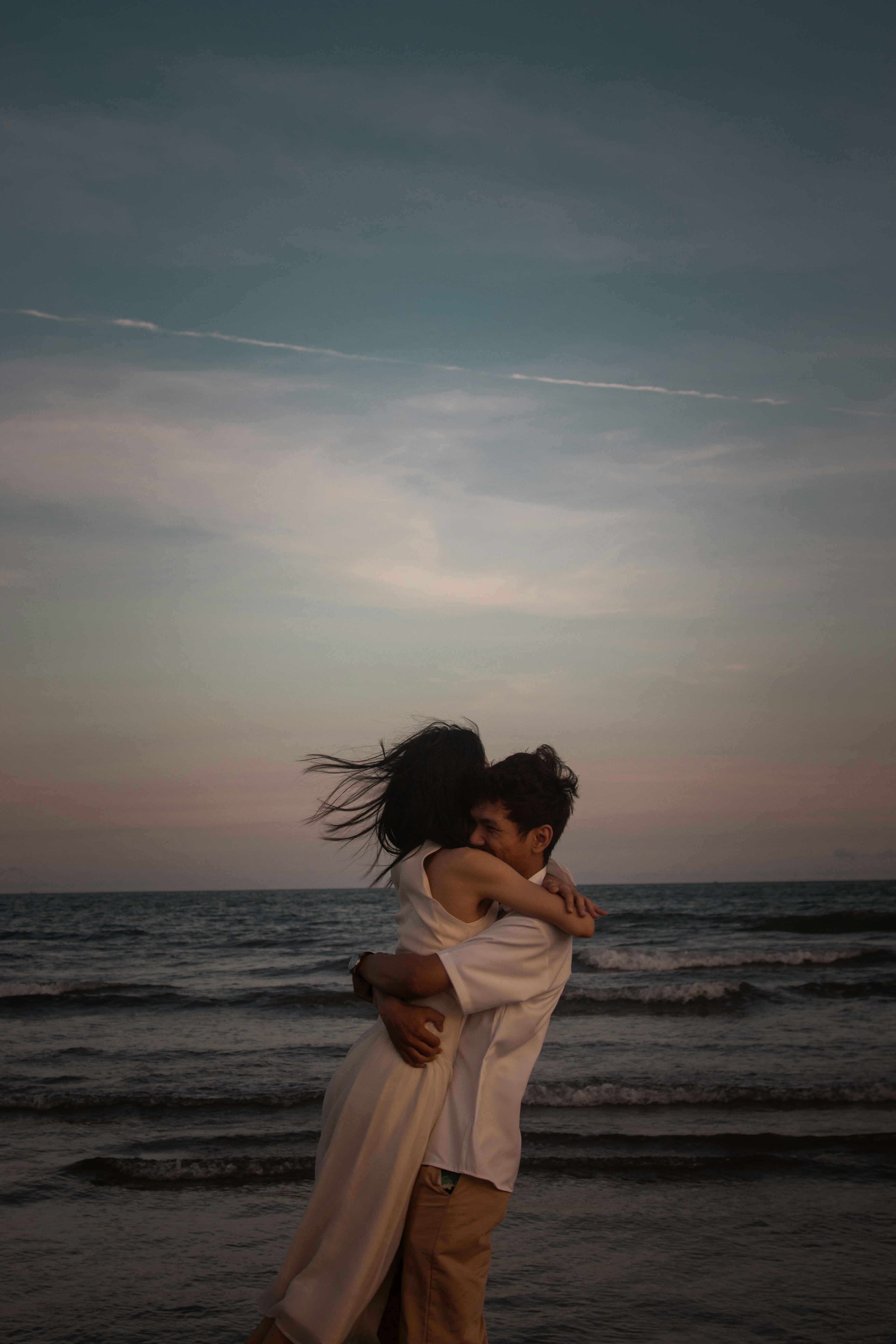 Couple Embracing at Beach Sunset