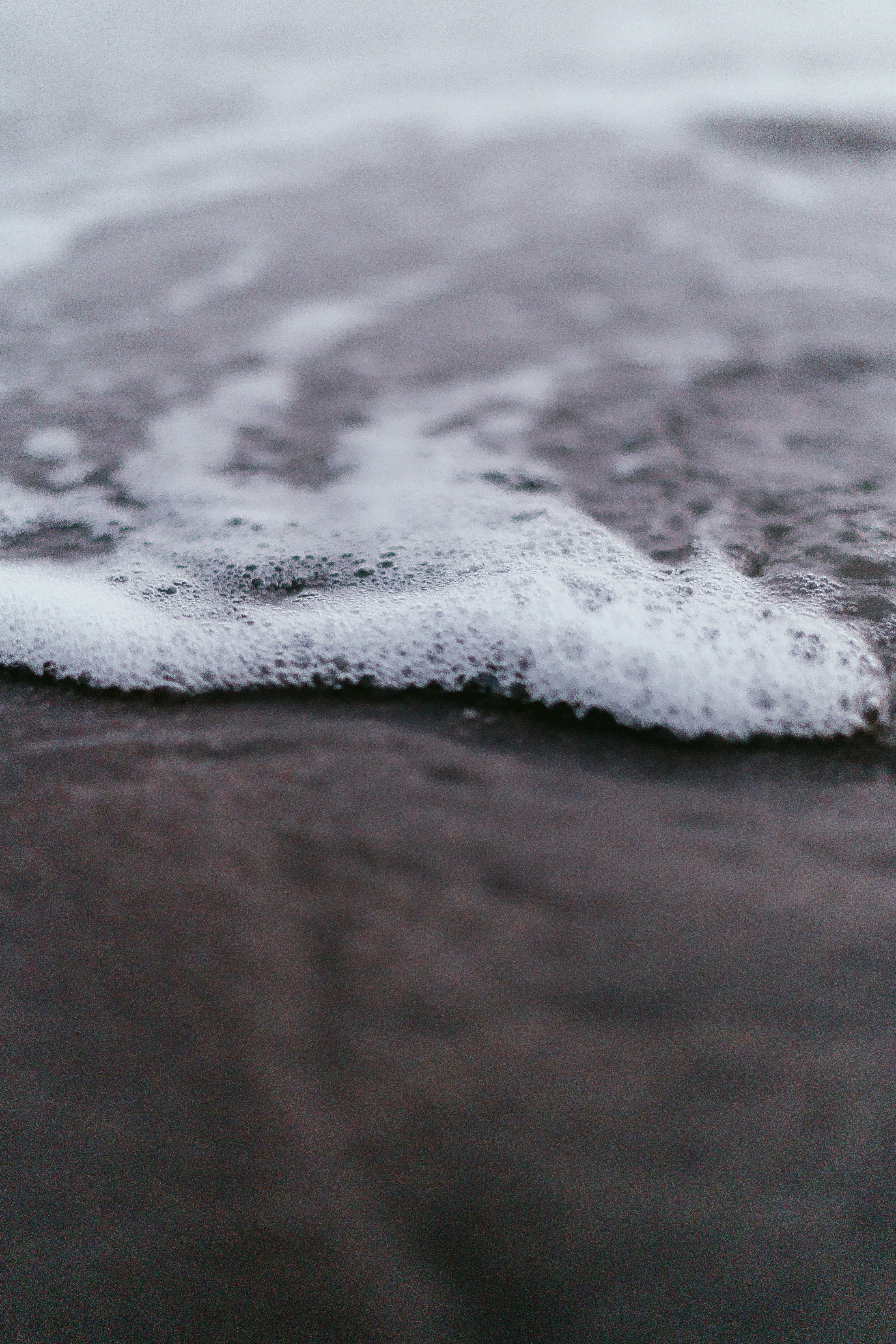 Sea Foam On Sandy Shore