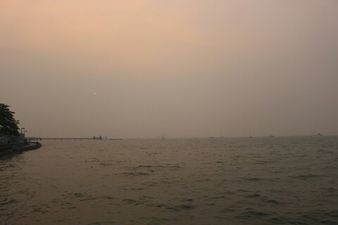 Hazy Coastal Sea at Sunset