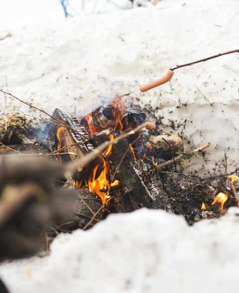 Roasting Sausages Over Winter Campfire