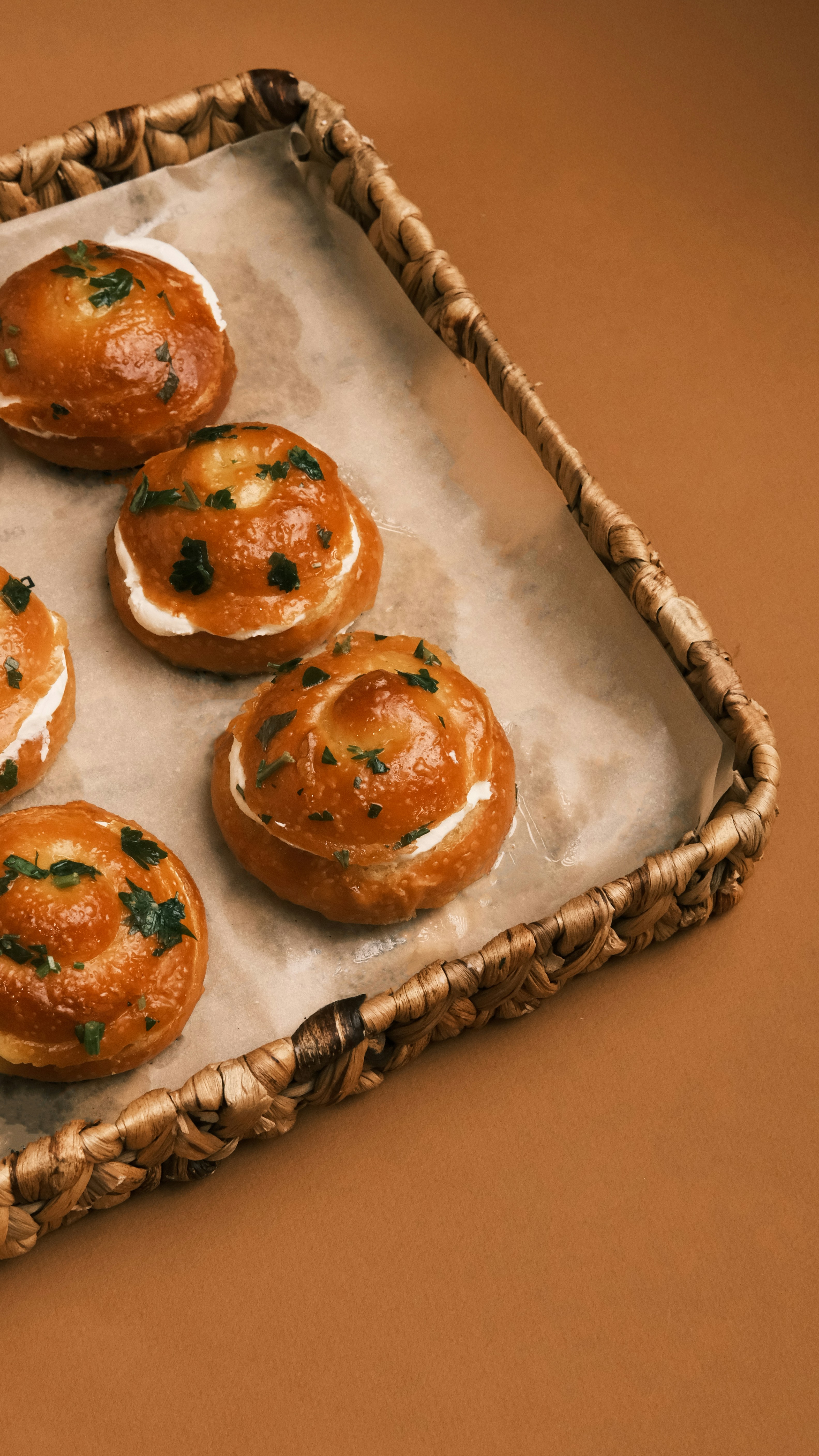 Glazed Herb Cream Buns on Woven Tray