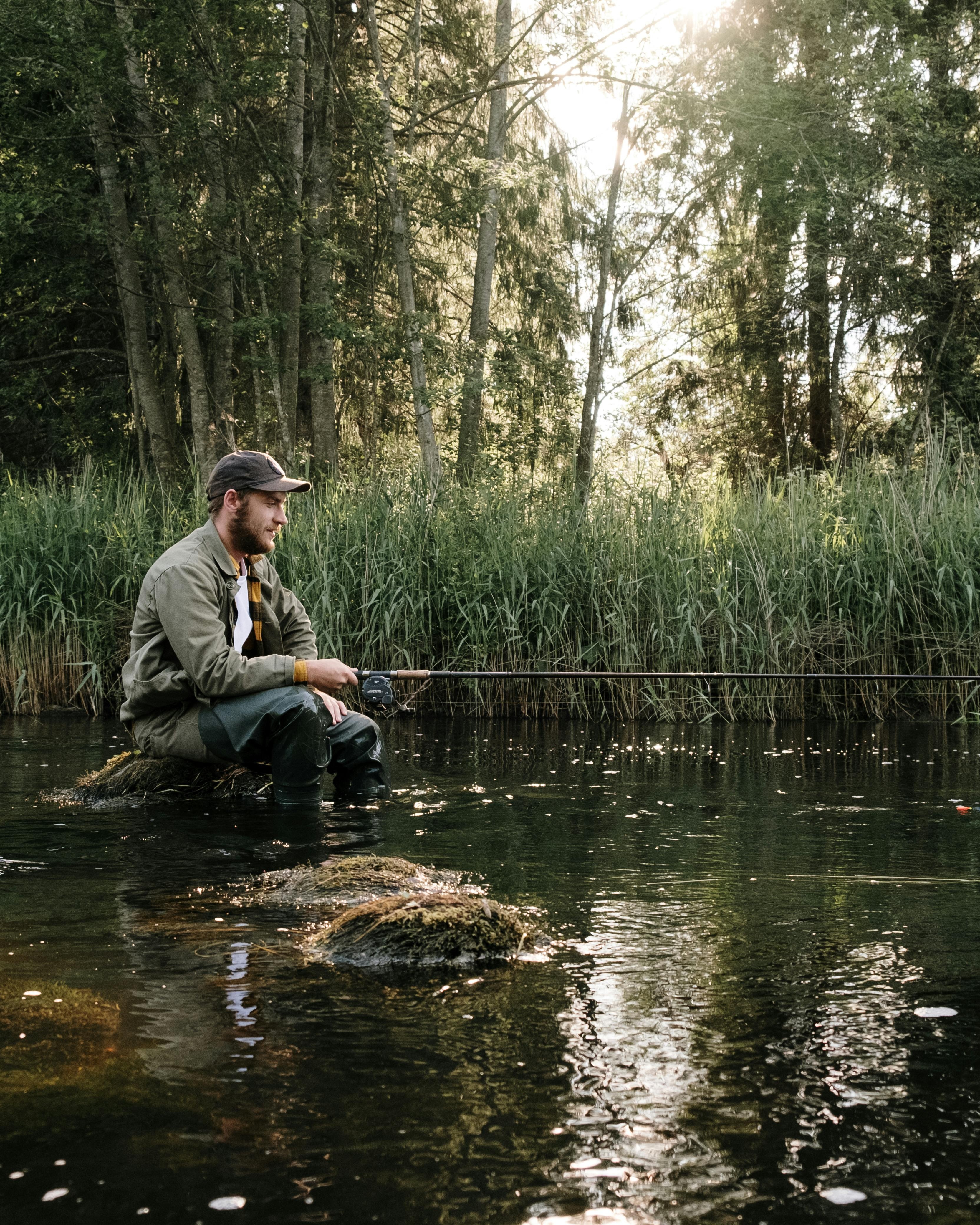 Man Fishing In Forest River