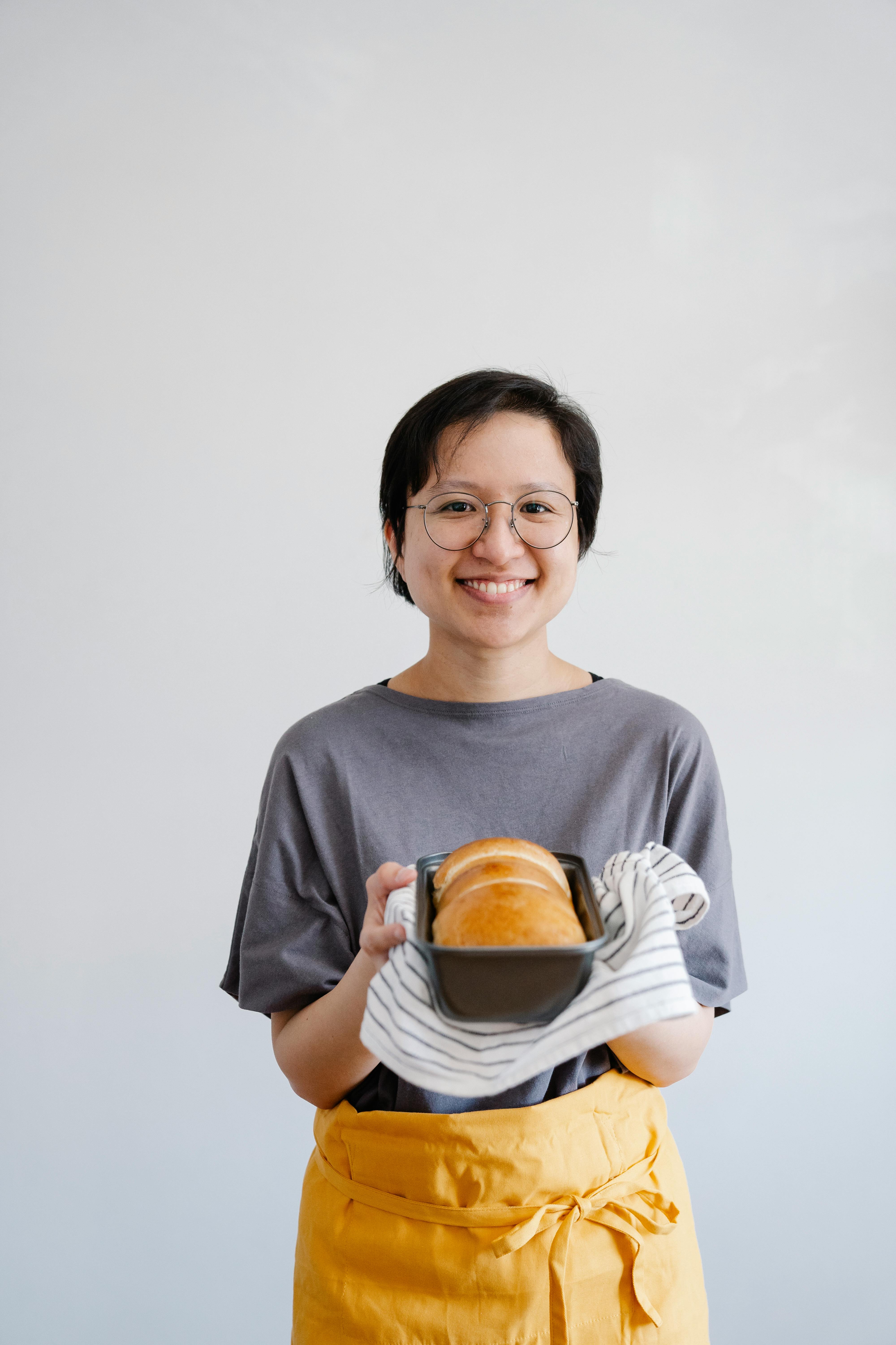 Home Baker Holding Freshly Baked Bread