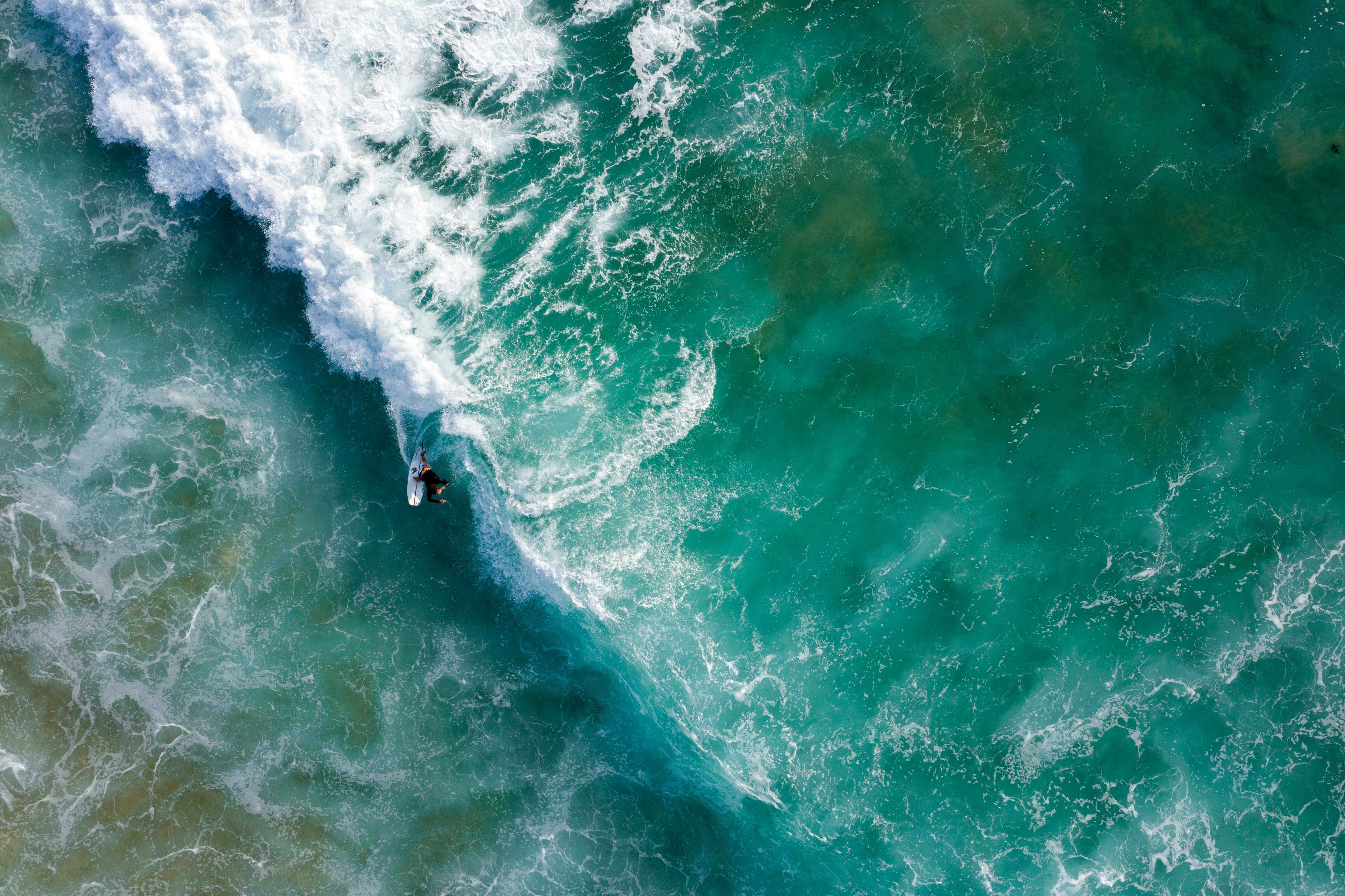 Aerial View of Surfer Riding Wave