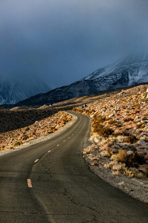 Winding Road Toward Snowy Mountains