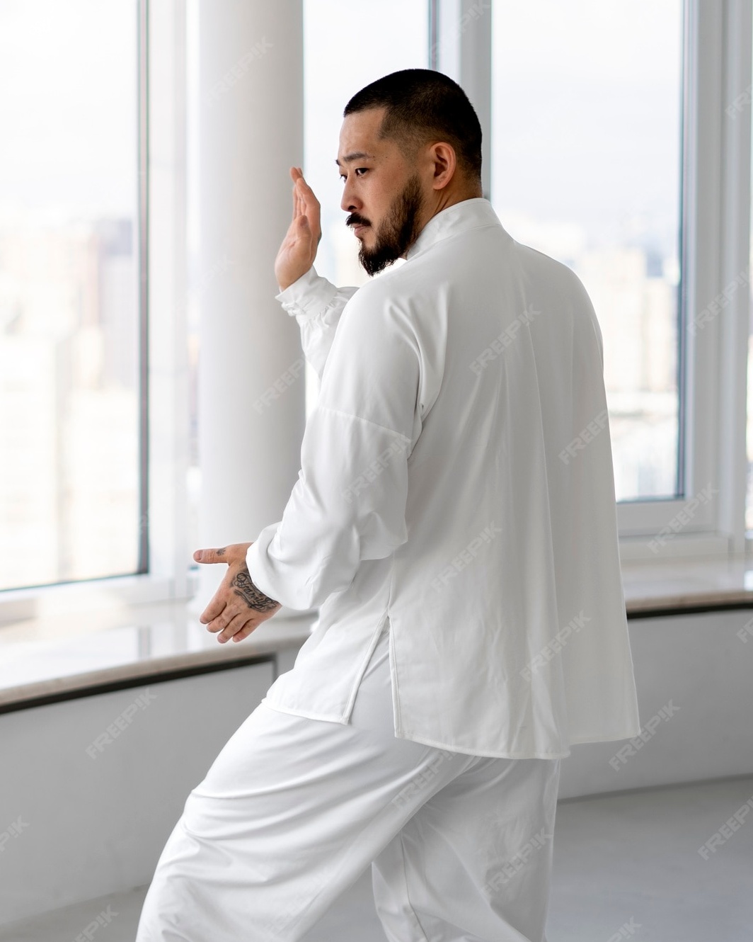 Man Practicing Tai Chi in Bright Room