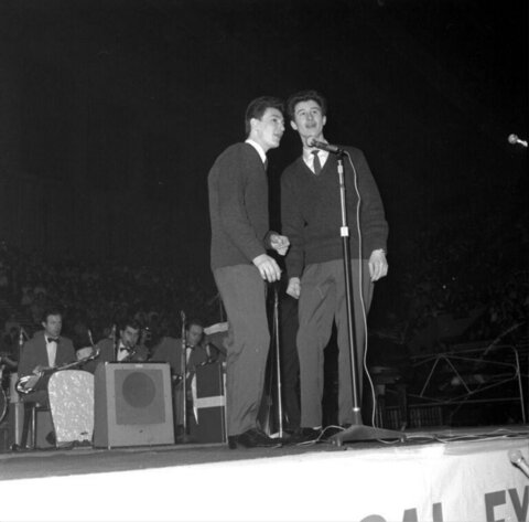 Two Vocalists Performing On Stage