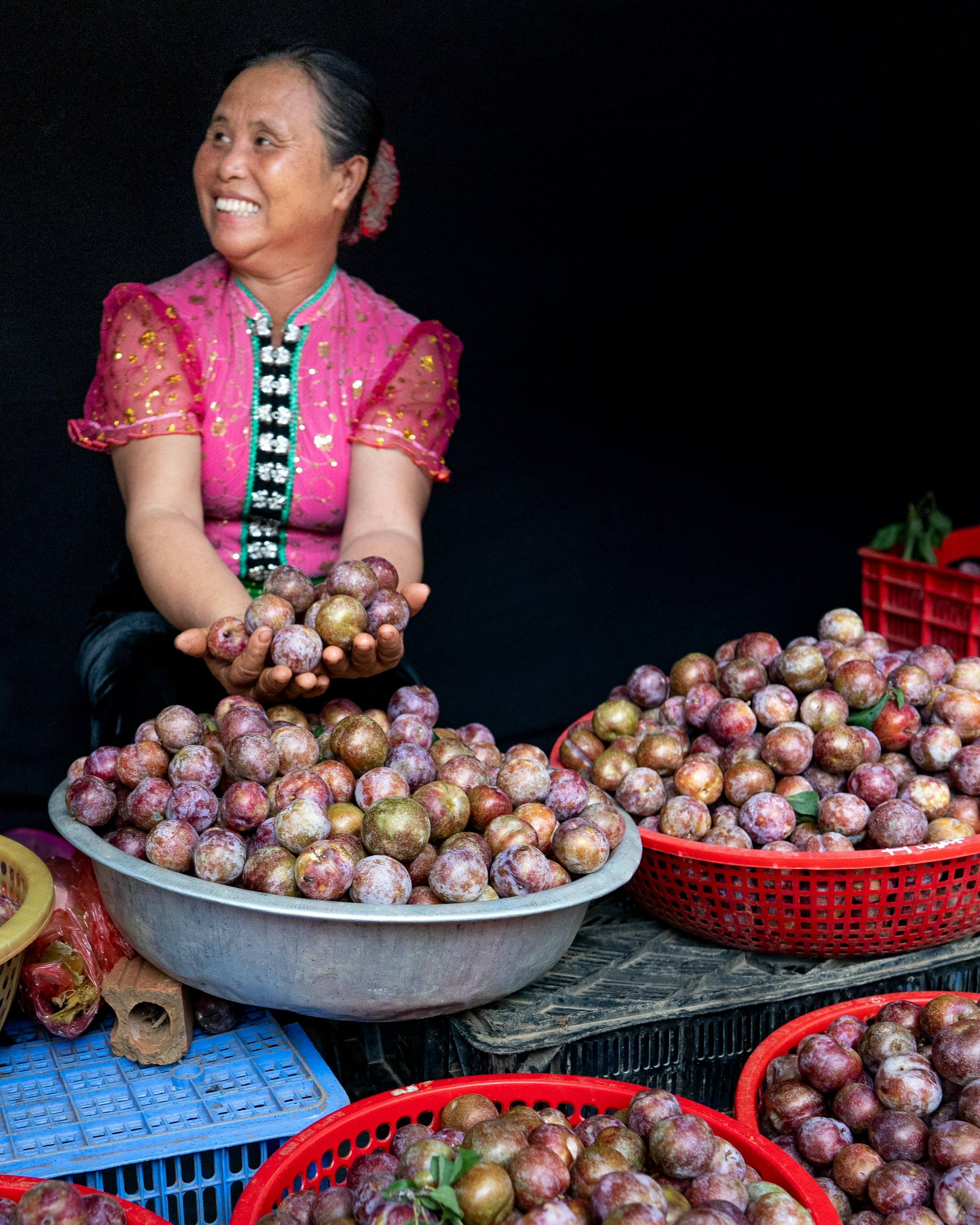 Farmer Displaying Fresh Harvested Plums