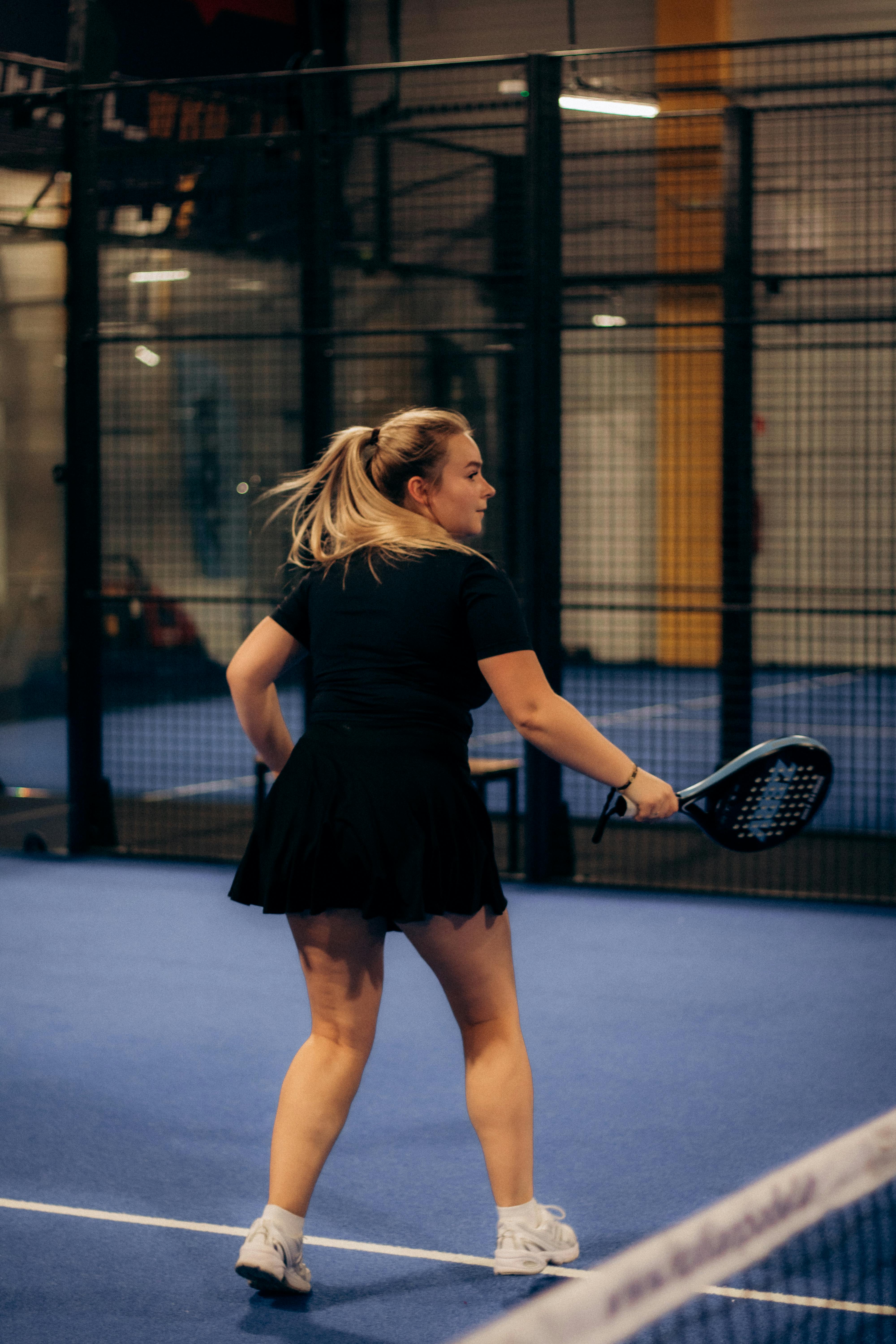 Woman Playing Padel on Indoor Court
