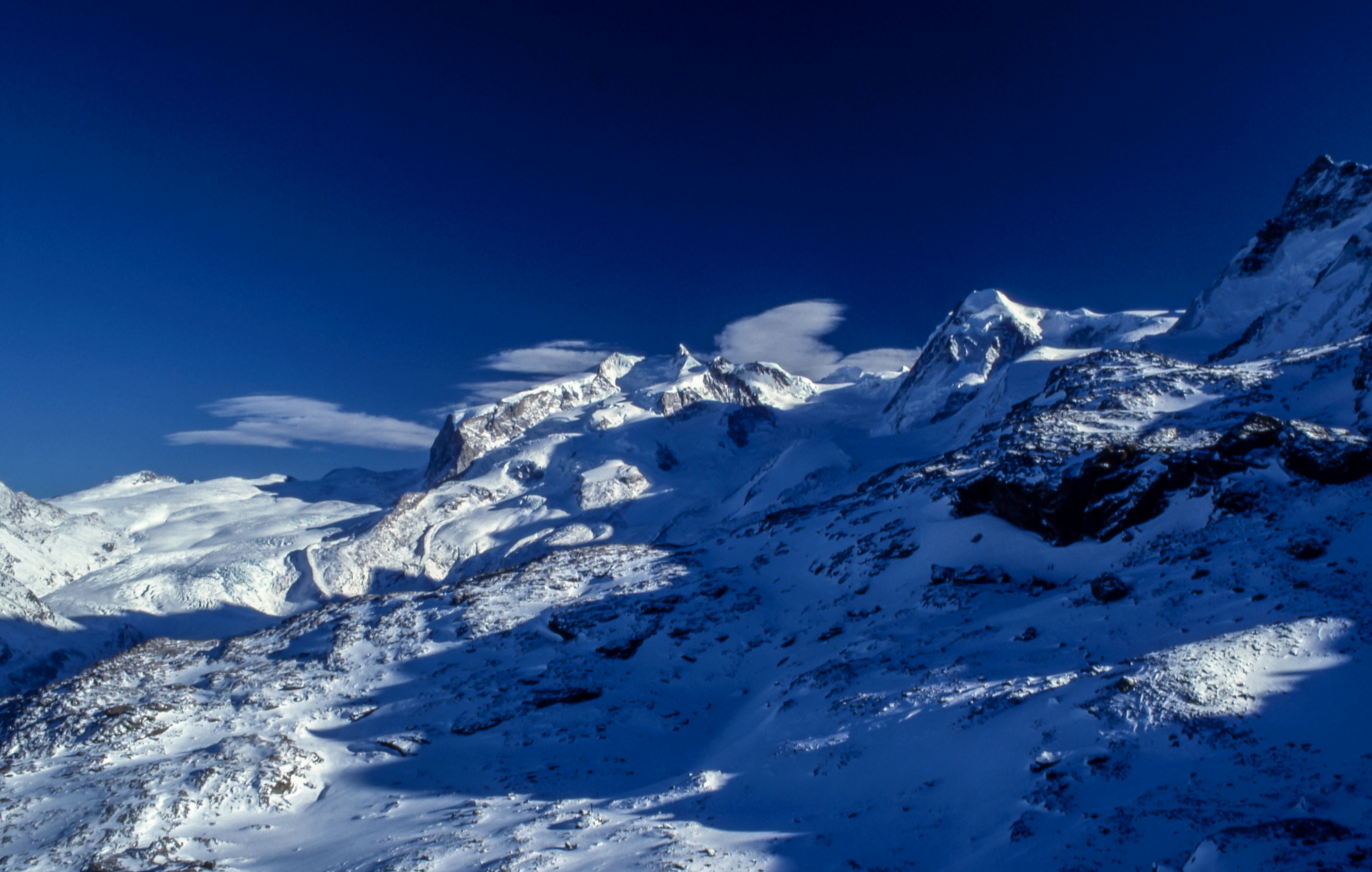 Snow-Covered Mountain Range Under Clear Sky