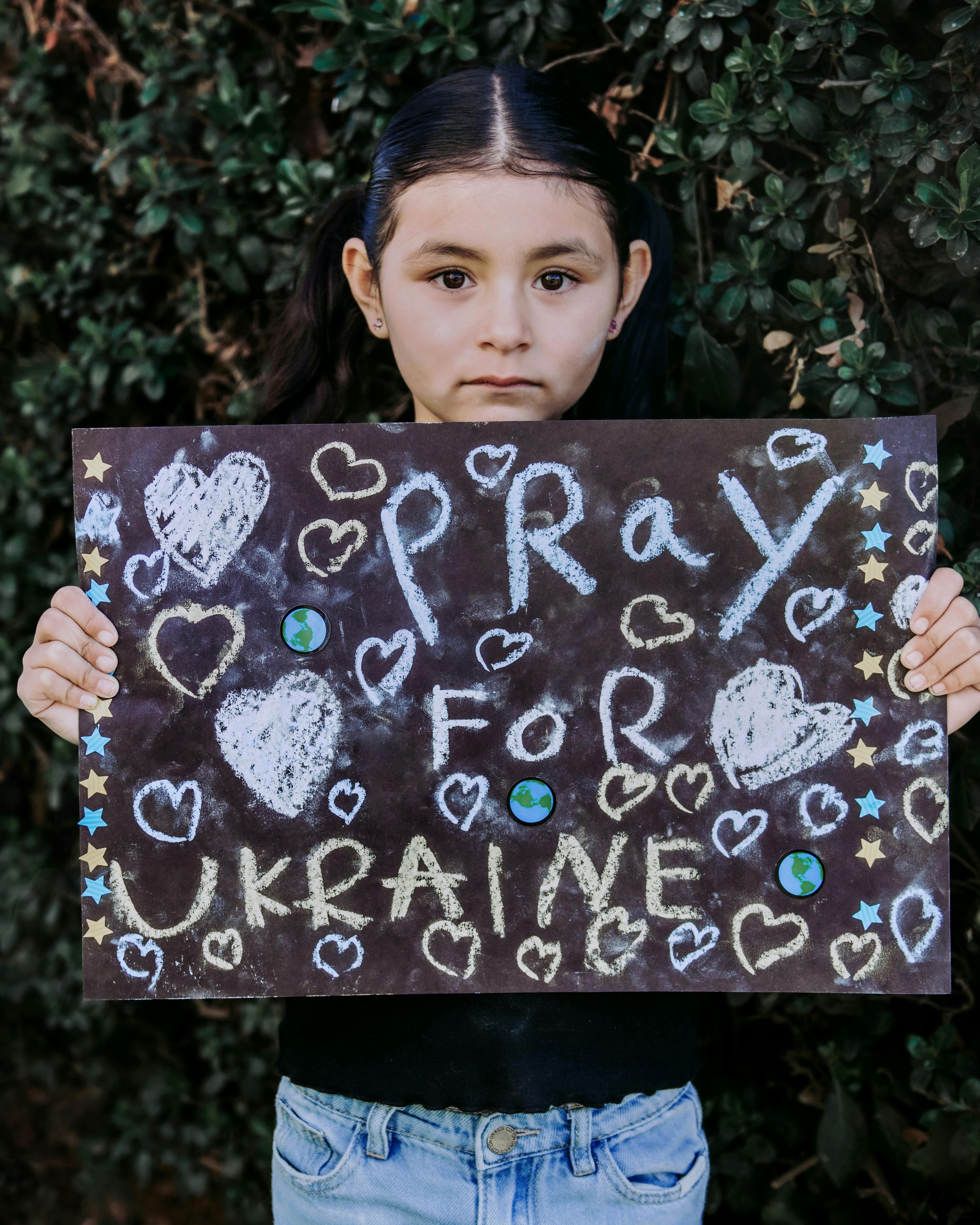 Girl Holding Pray For Ukraine Sign