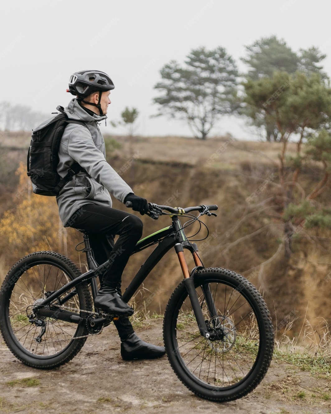 Mountain Biker Stopped on Foggy Hilltop