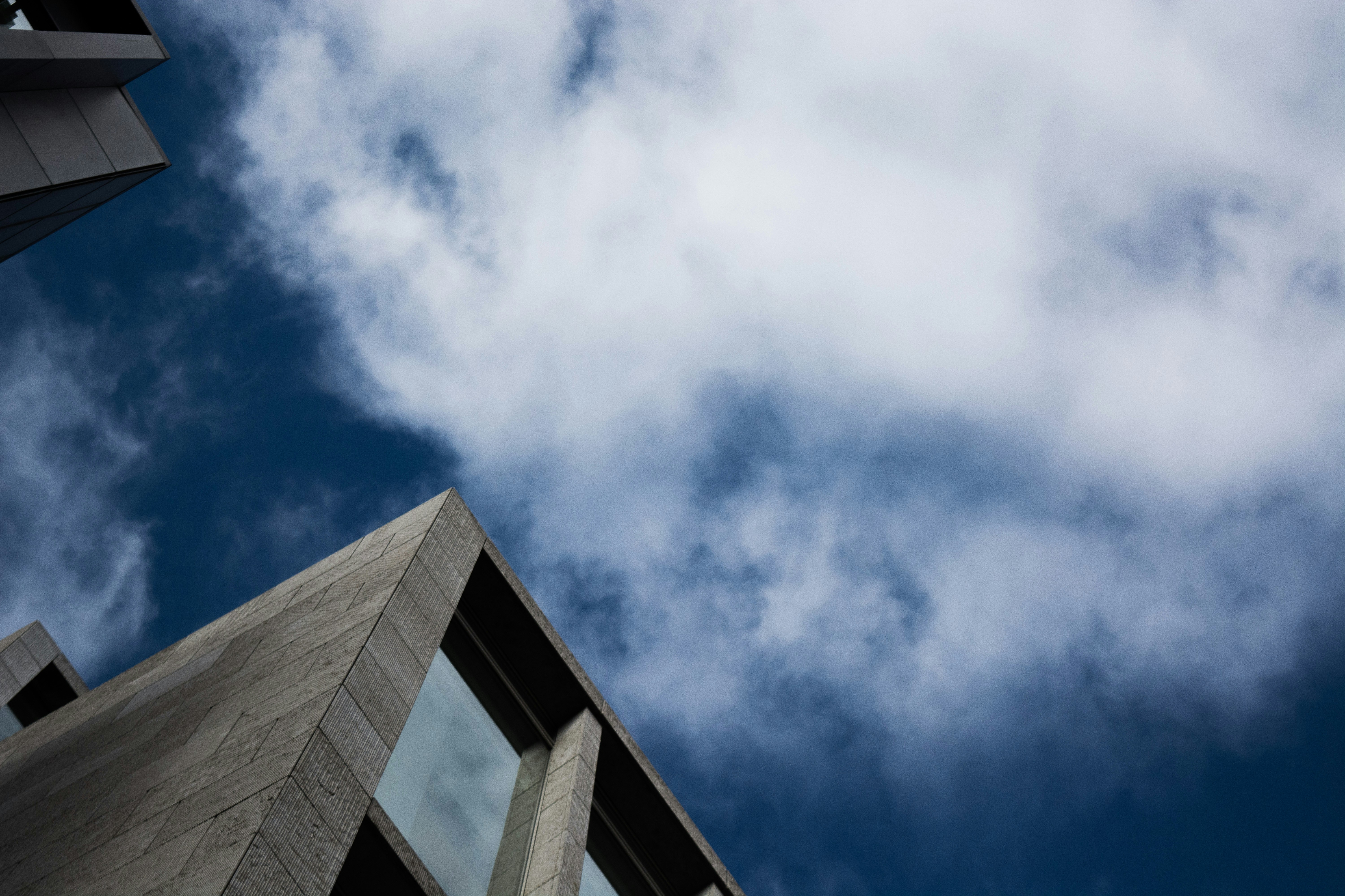 Concrete Buildings Against Cloudy Sky