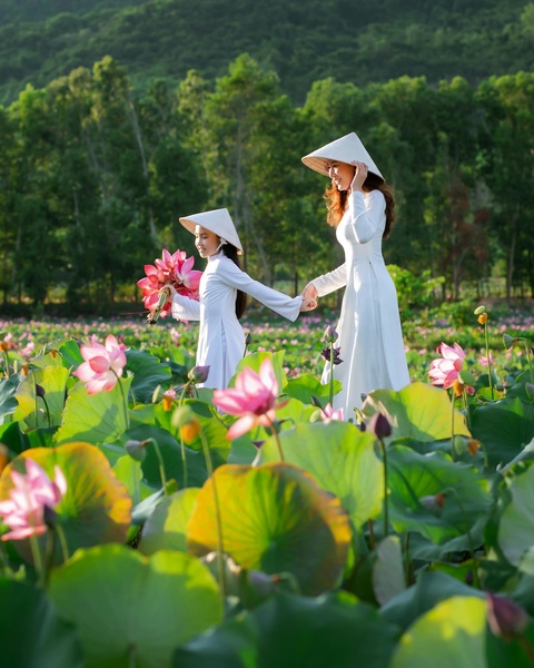 Two Women Walking in Lotus Field