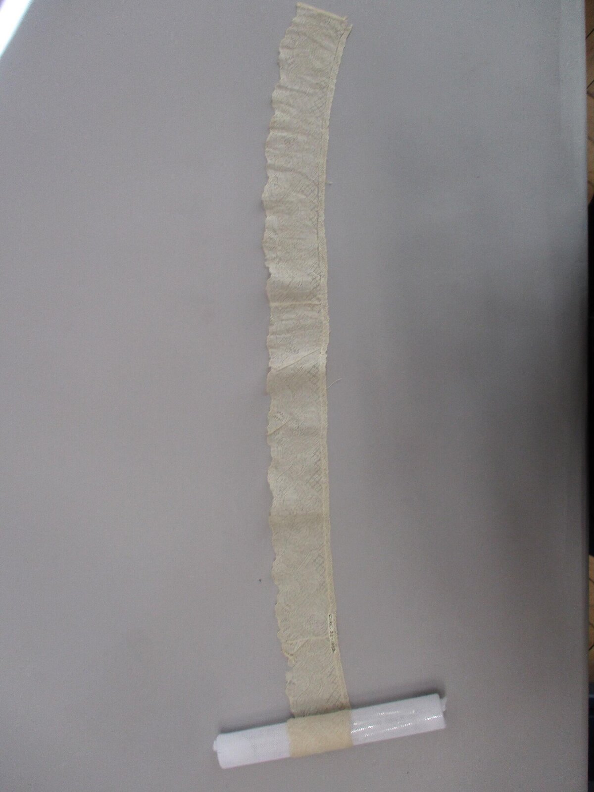 Cream Lace Trim on Gray Surface