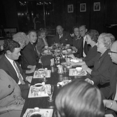Group of Adults Dining at Long Table