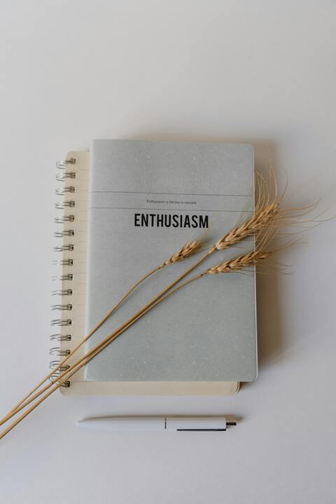 Notebook with dried wheat and pen