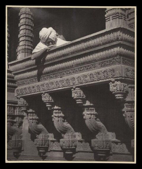 Man at Carved Stone Temple Balcony