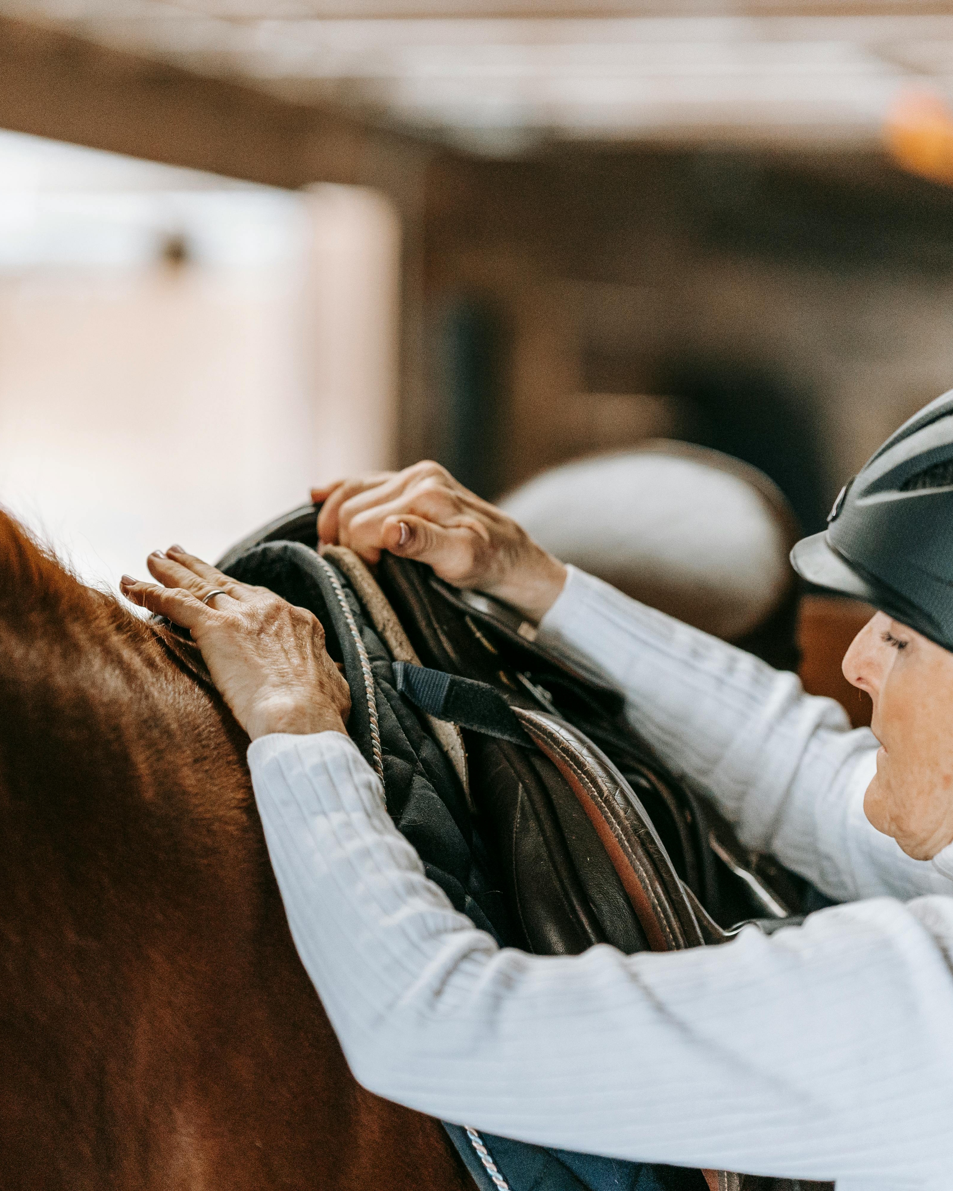 Rider Adjusting Saddle on Horse