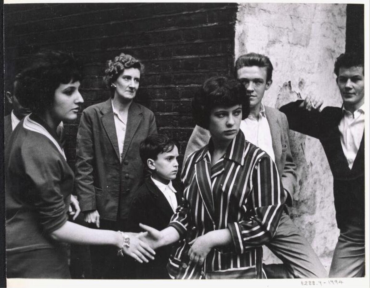 Two Women Shake Hands Group Photo