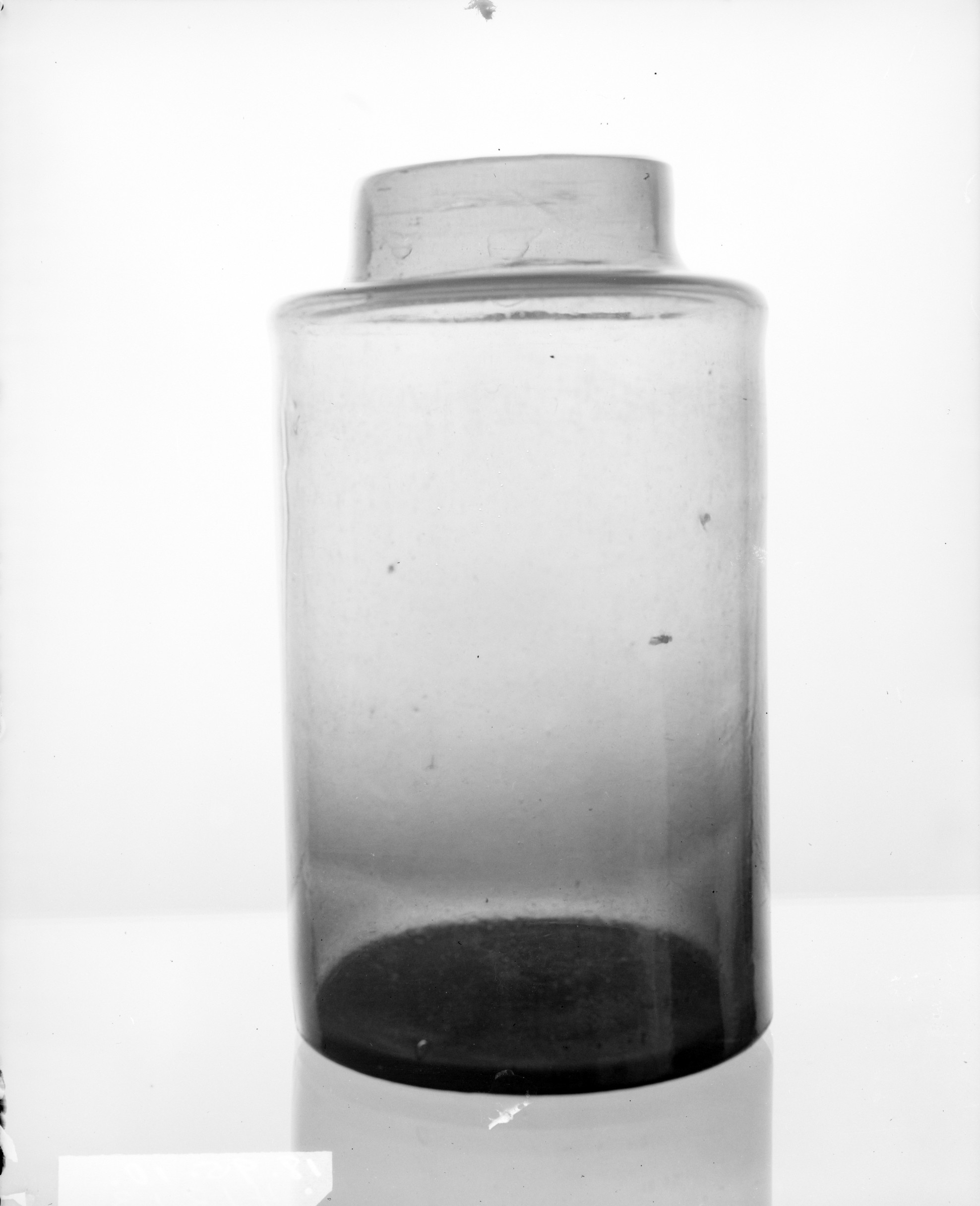 Glass Jar with Dark Residue