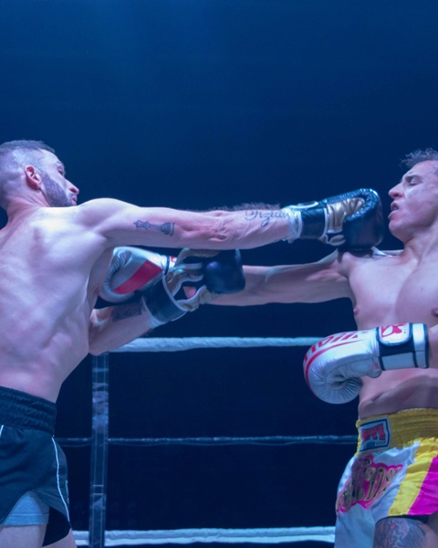 Two Boxers Exchanging Punches in Boxing Ring