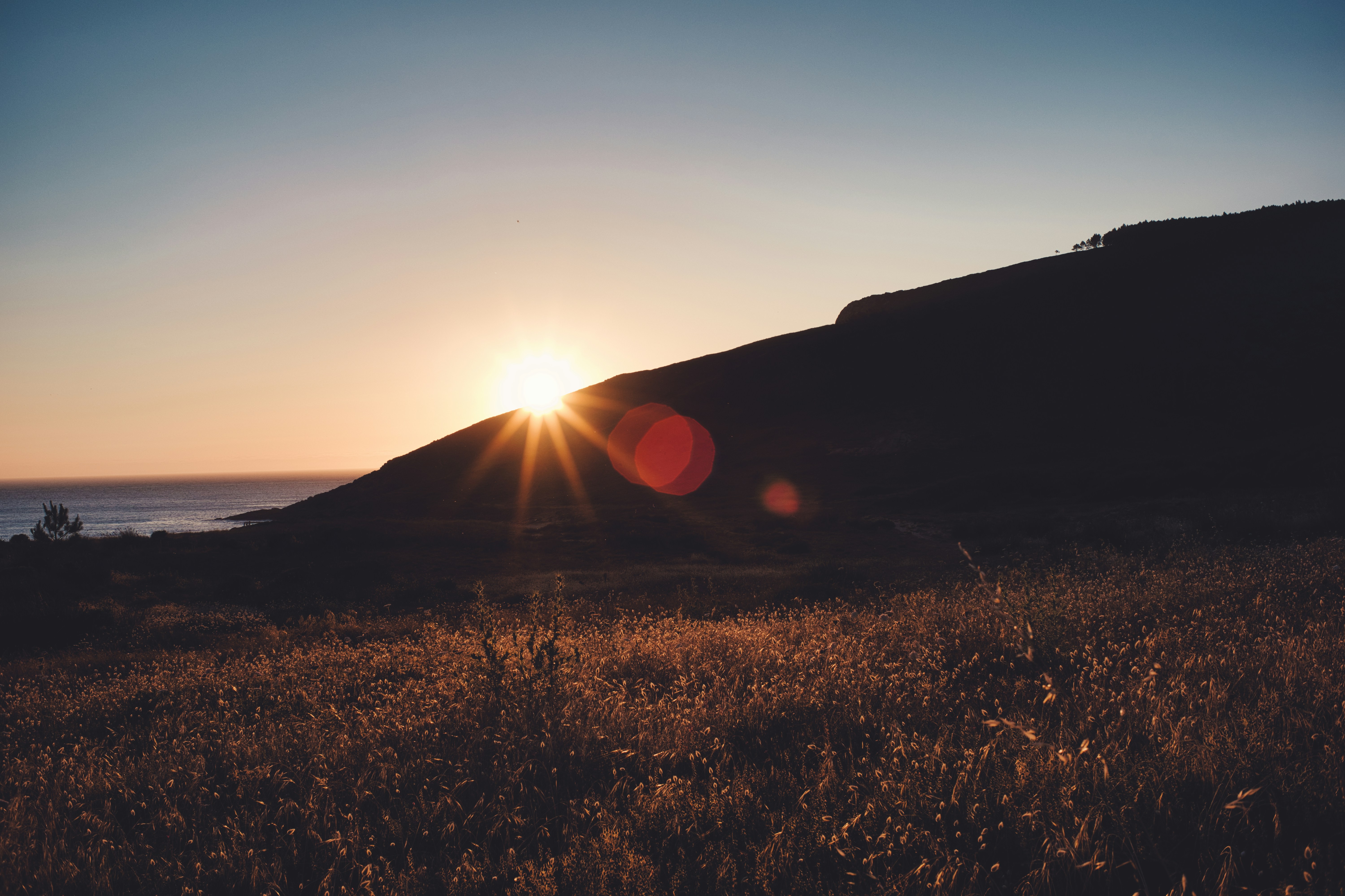 Sunset Behind Coastal Hill