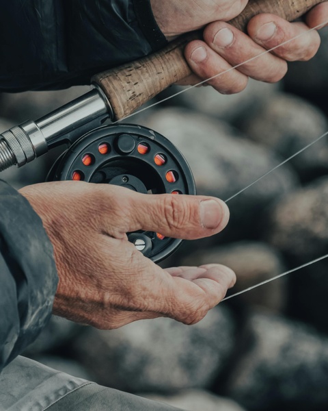 Hands Handling a Fly Fishing Rod