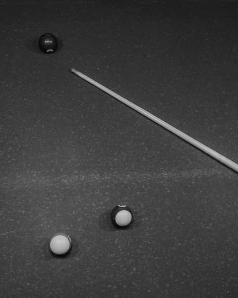 Billiard Balls and Cue on Pool Table