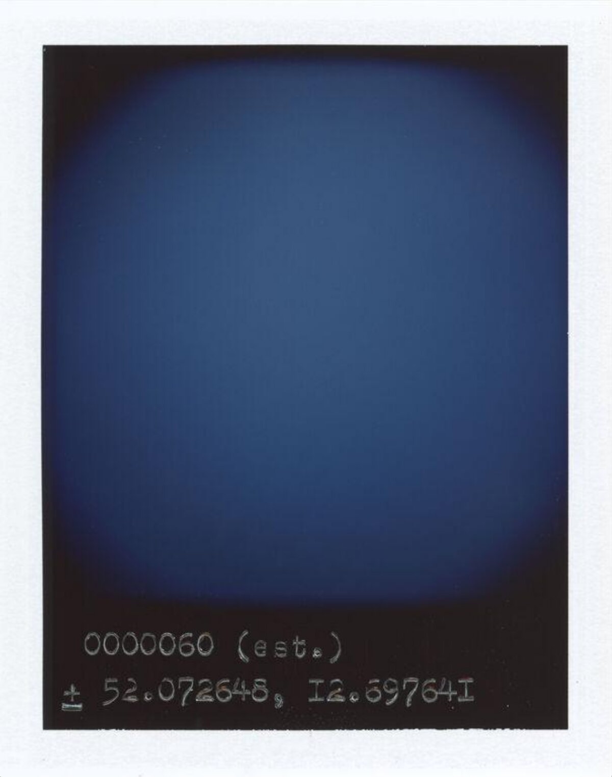 Blue Polaroid With Handwritten Coordinates