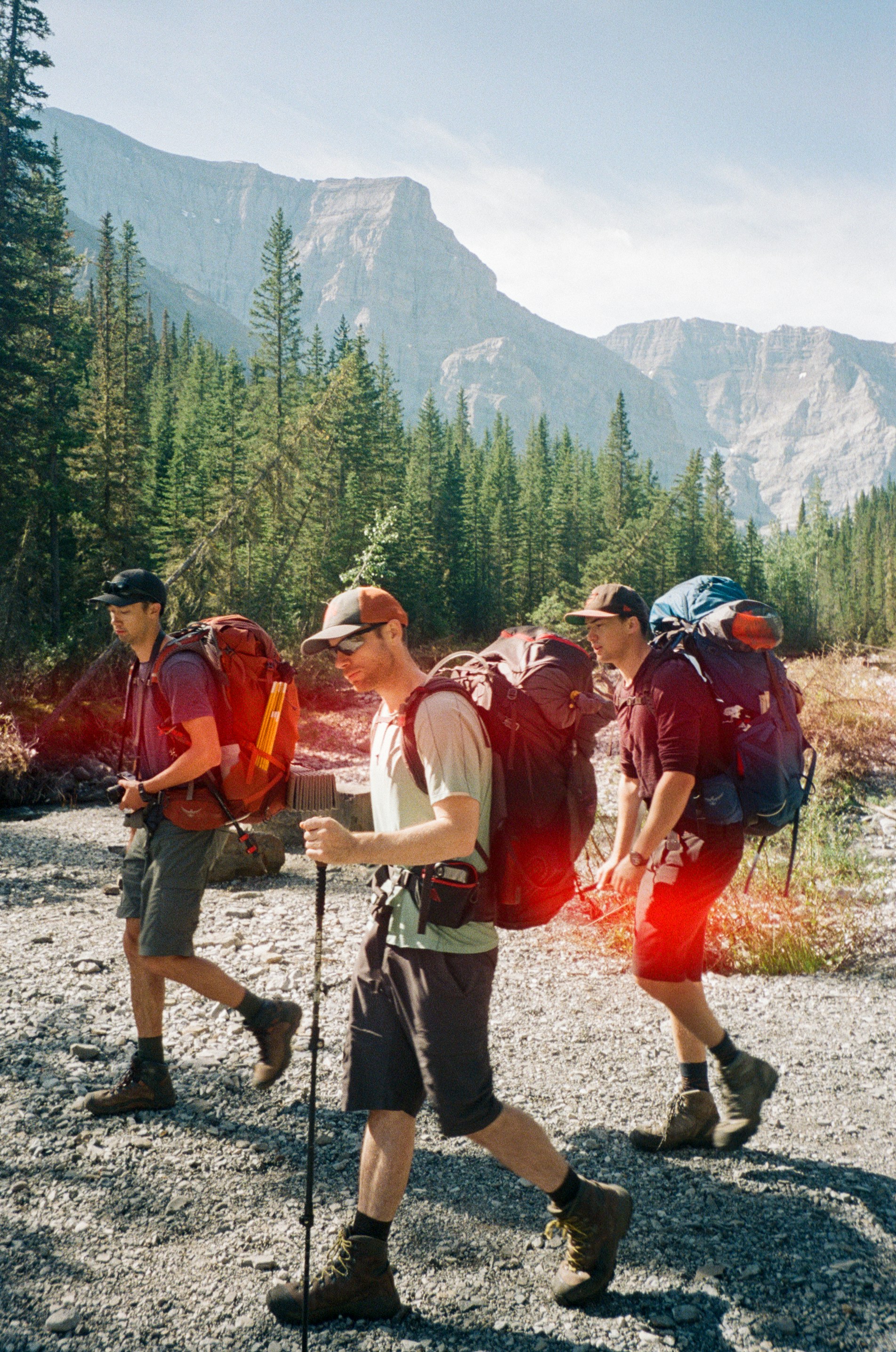 Three Backpackers Hiking Rocky Mountains