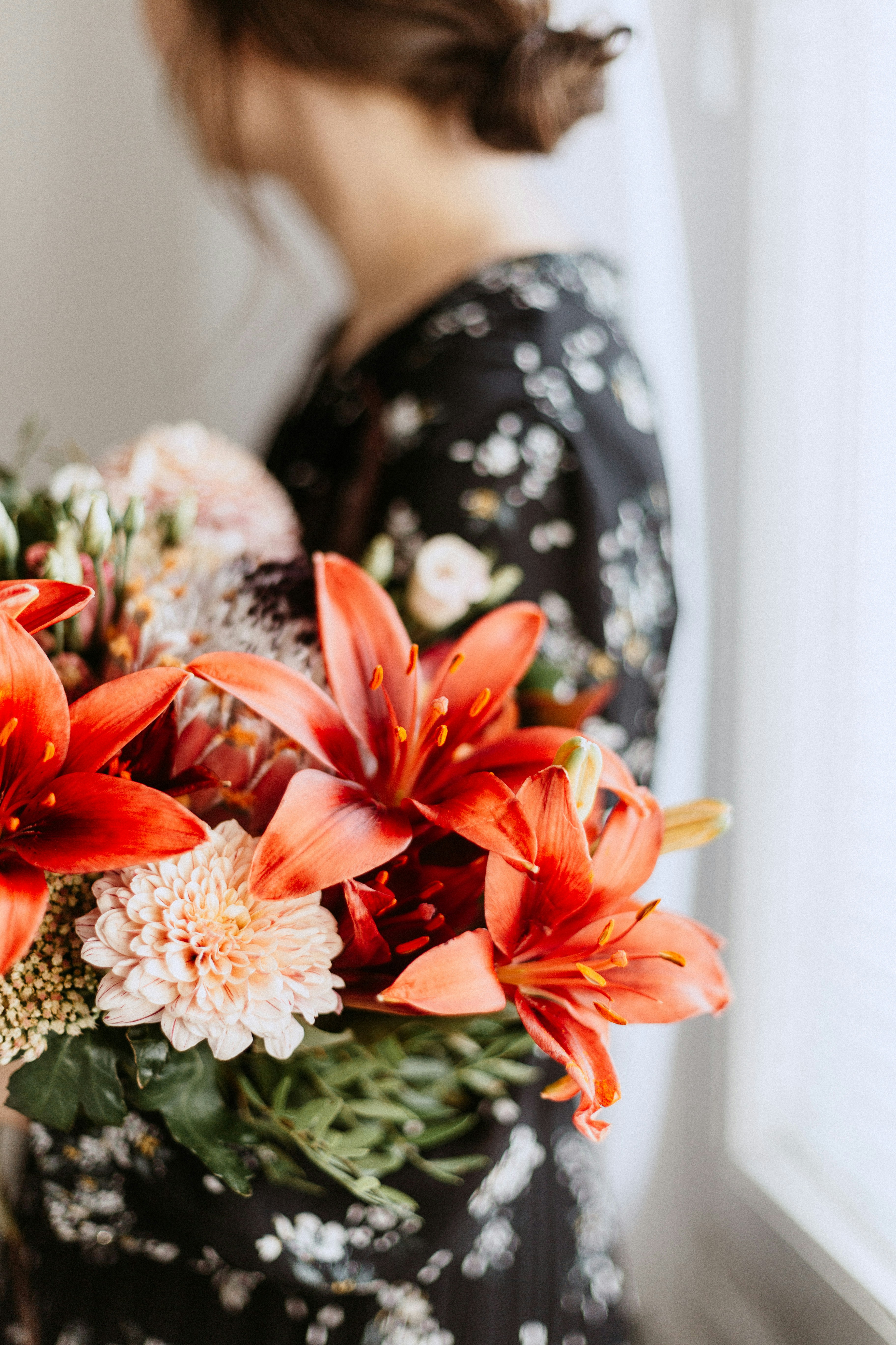 Woman Holding Orange Lily Bouquet