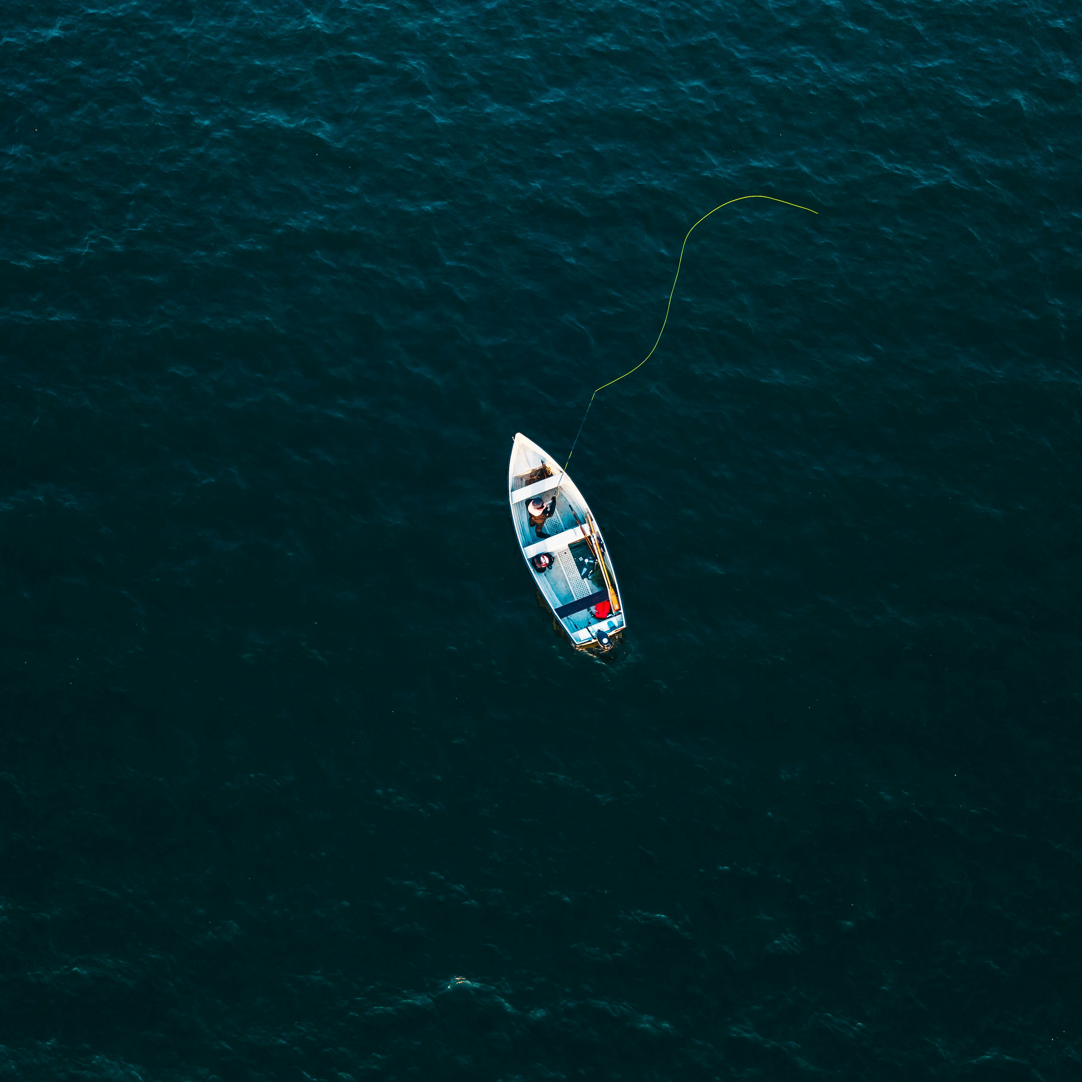 Aerial View of Lone Fisherman on Water