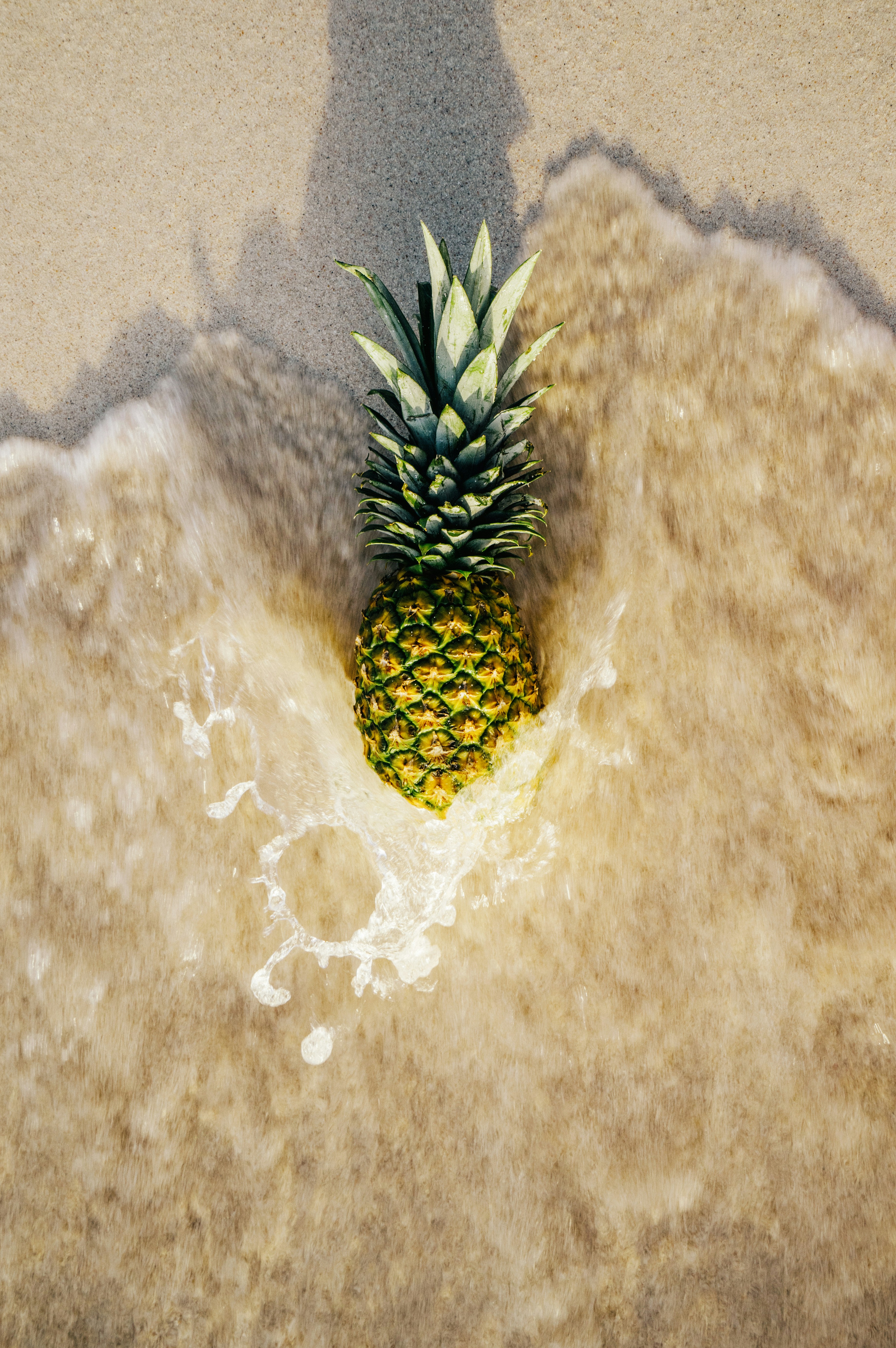 Pineapple on Beach Washed by Wave