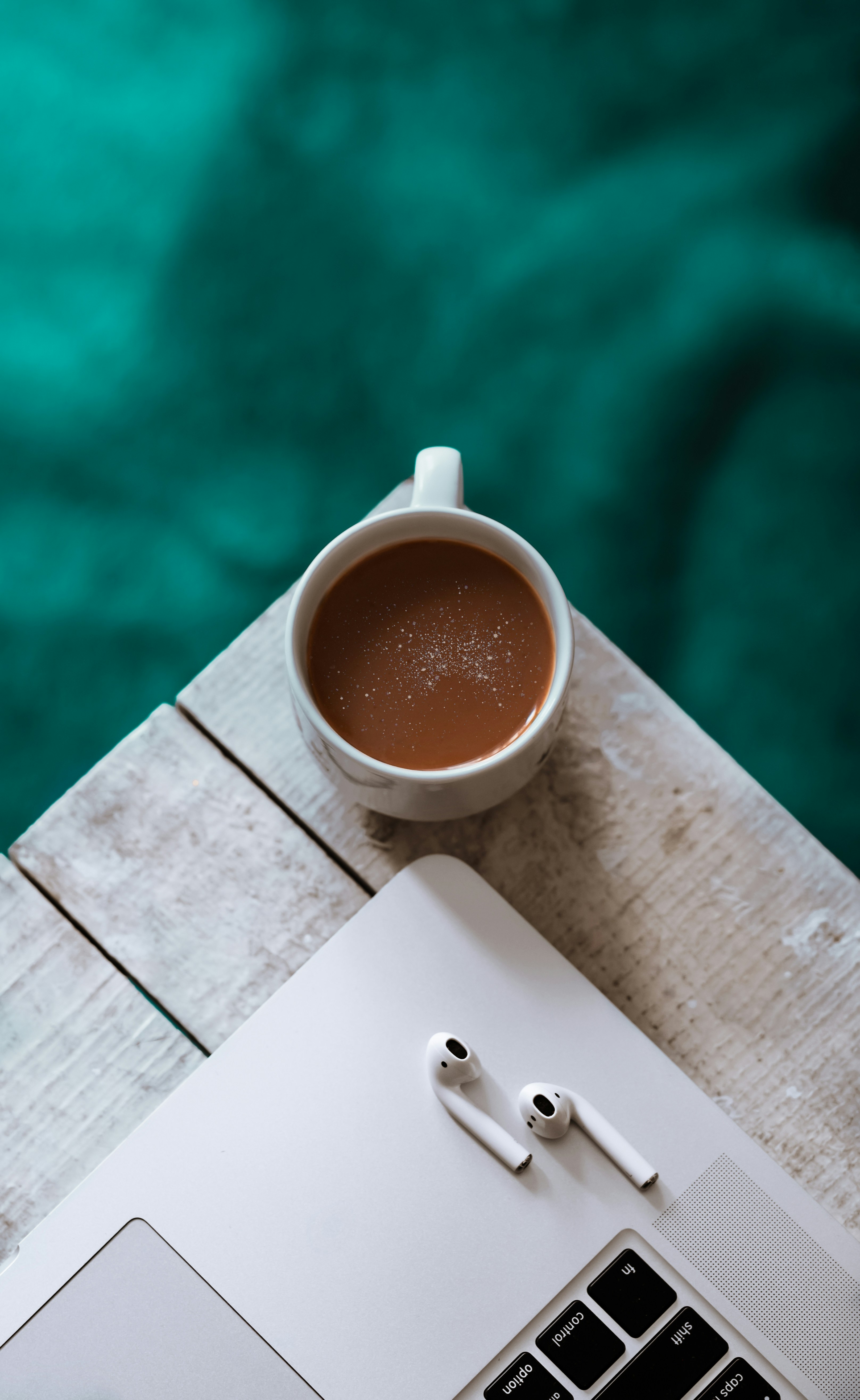 Coffee and Work Setup on Wooden Table