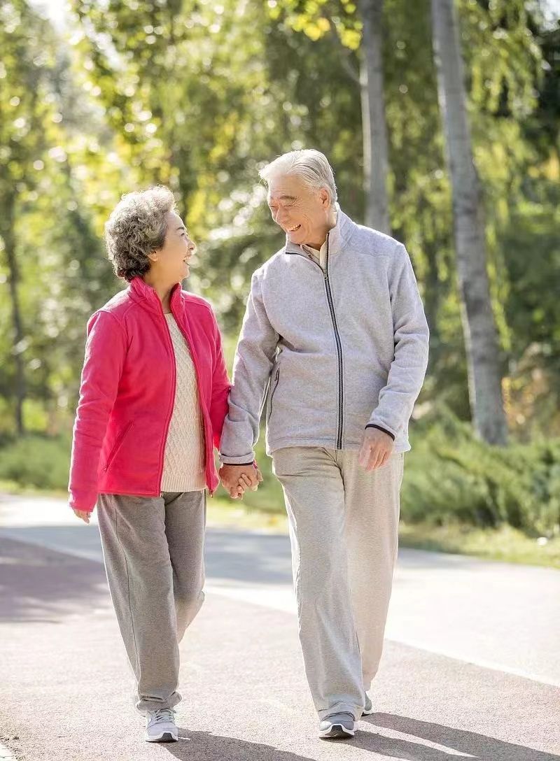 Elderly Couple Walking in Park