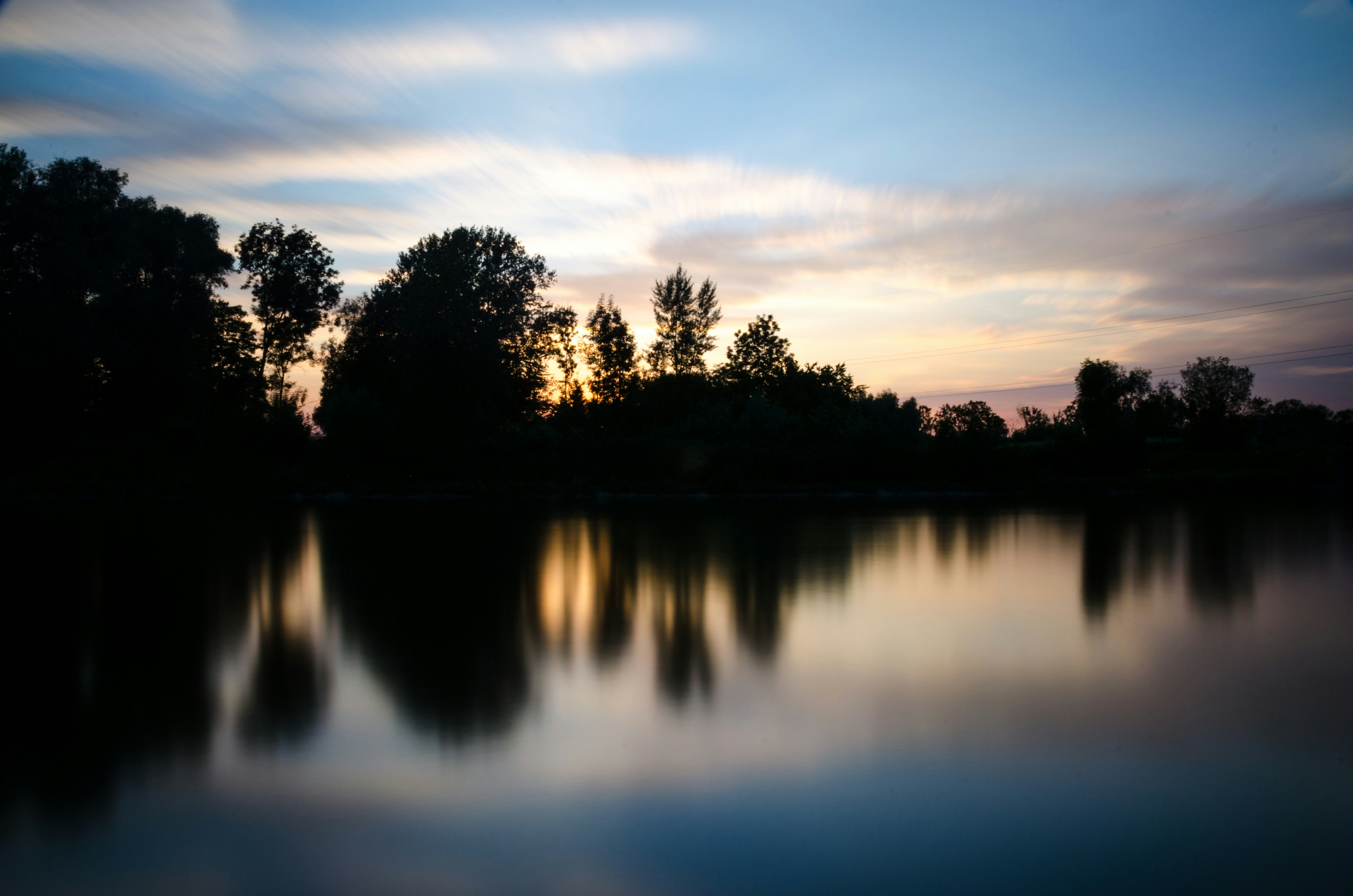 Sunset River with Tree Silhouettes