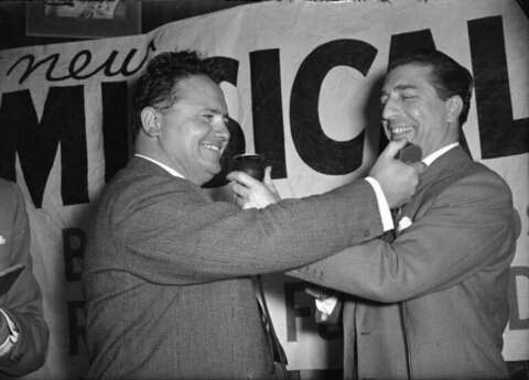 Two Laughing Men at Musical Event