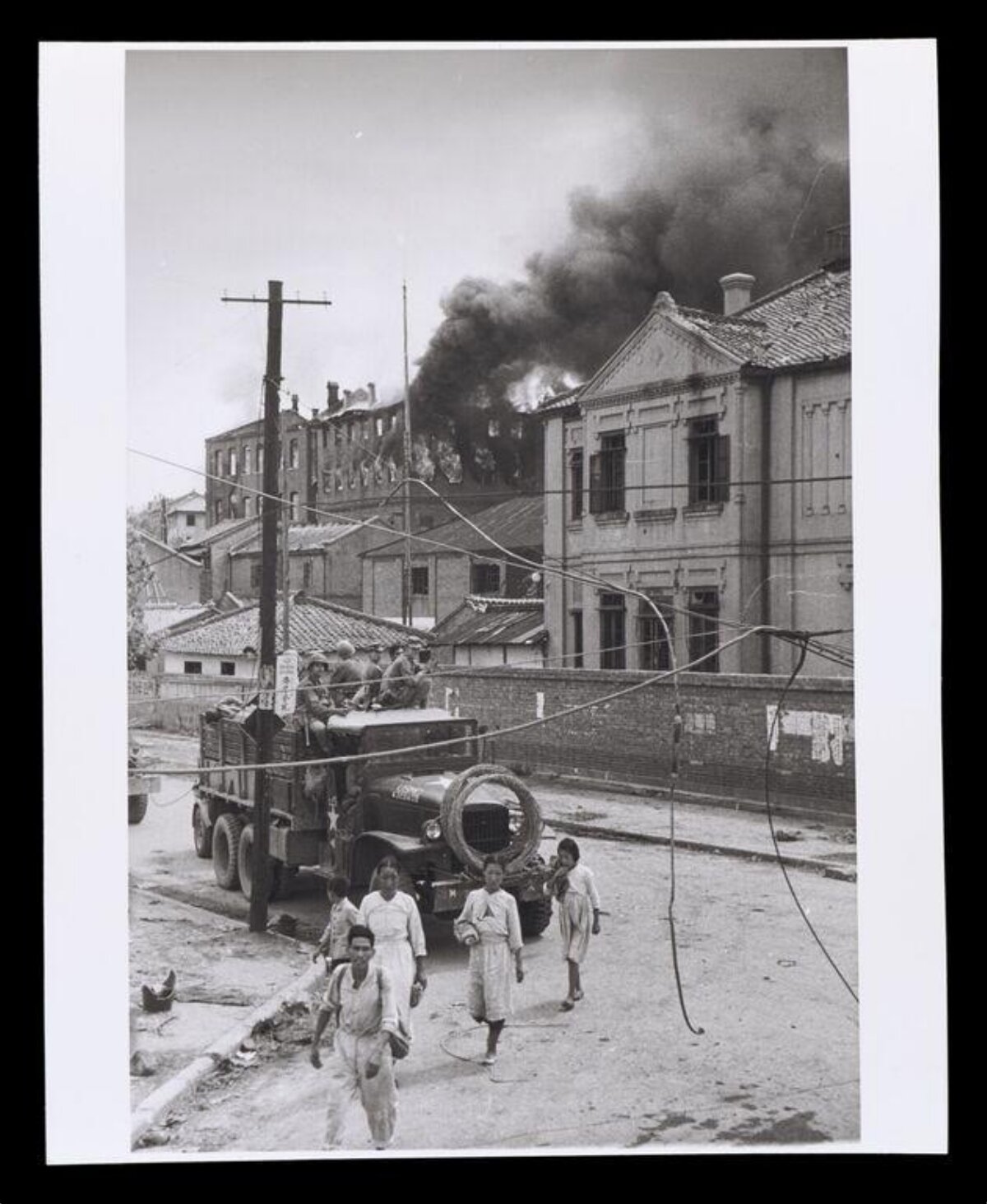 Wartime Street with Burning Building